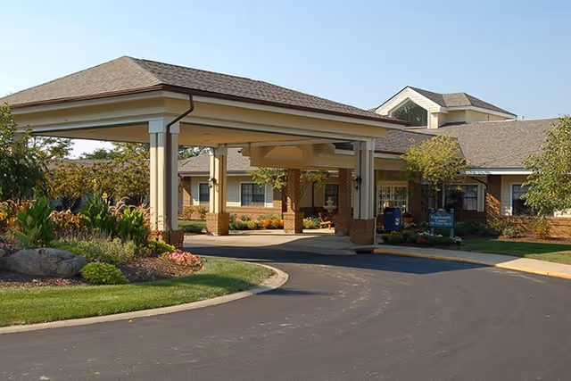 Covered entrance to Cedarhurst Senior Living facility with landscaping and curved driveway.