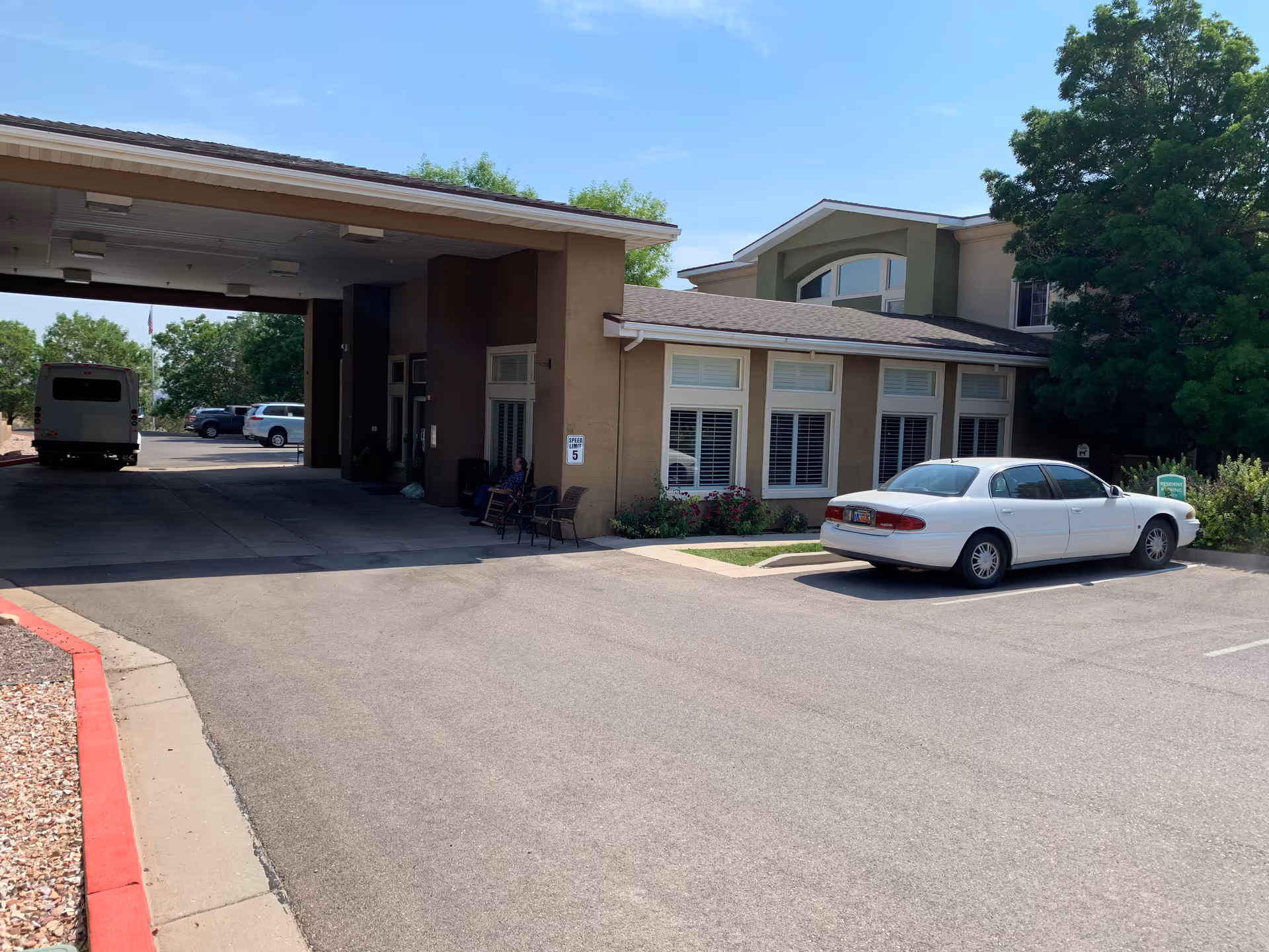 Exterior view of Our House Assisted Living Cedar City with a white car parked in front.