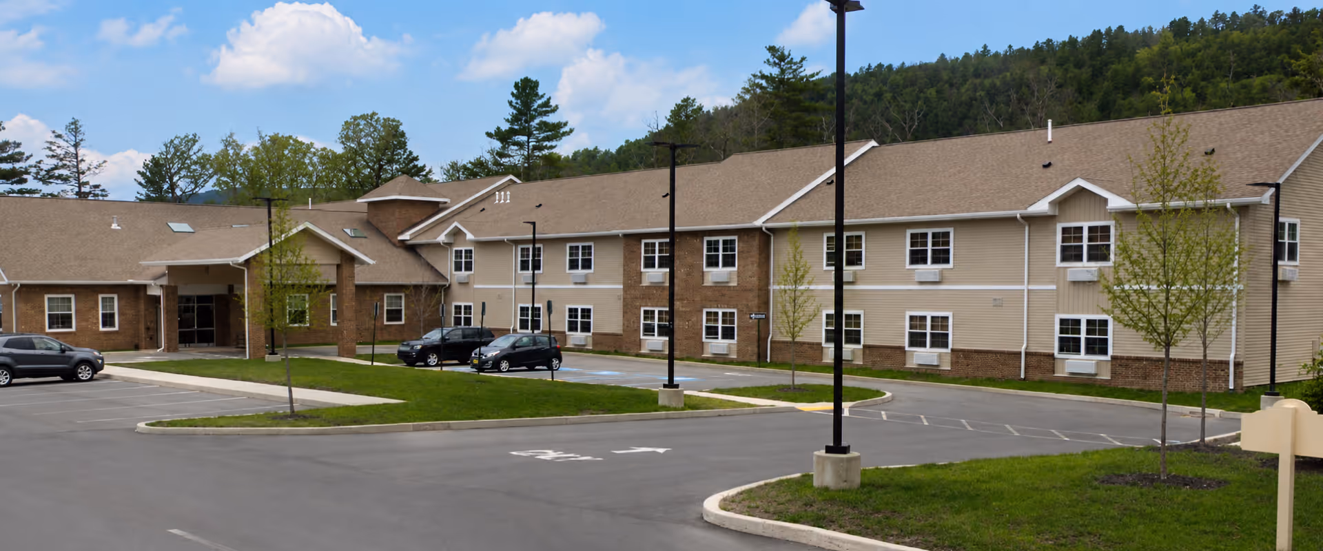 Exterior view of Delaware Valley Personal Care Residence with parking lot and landscaped grounds.