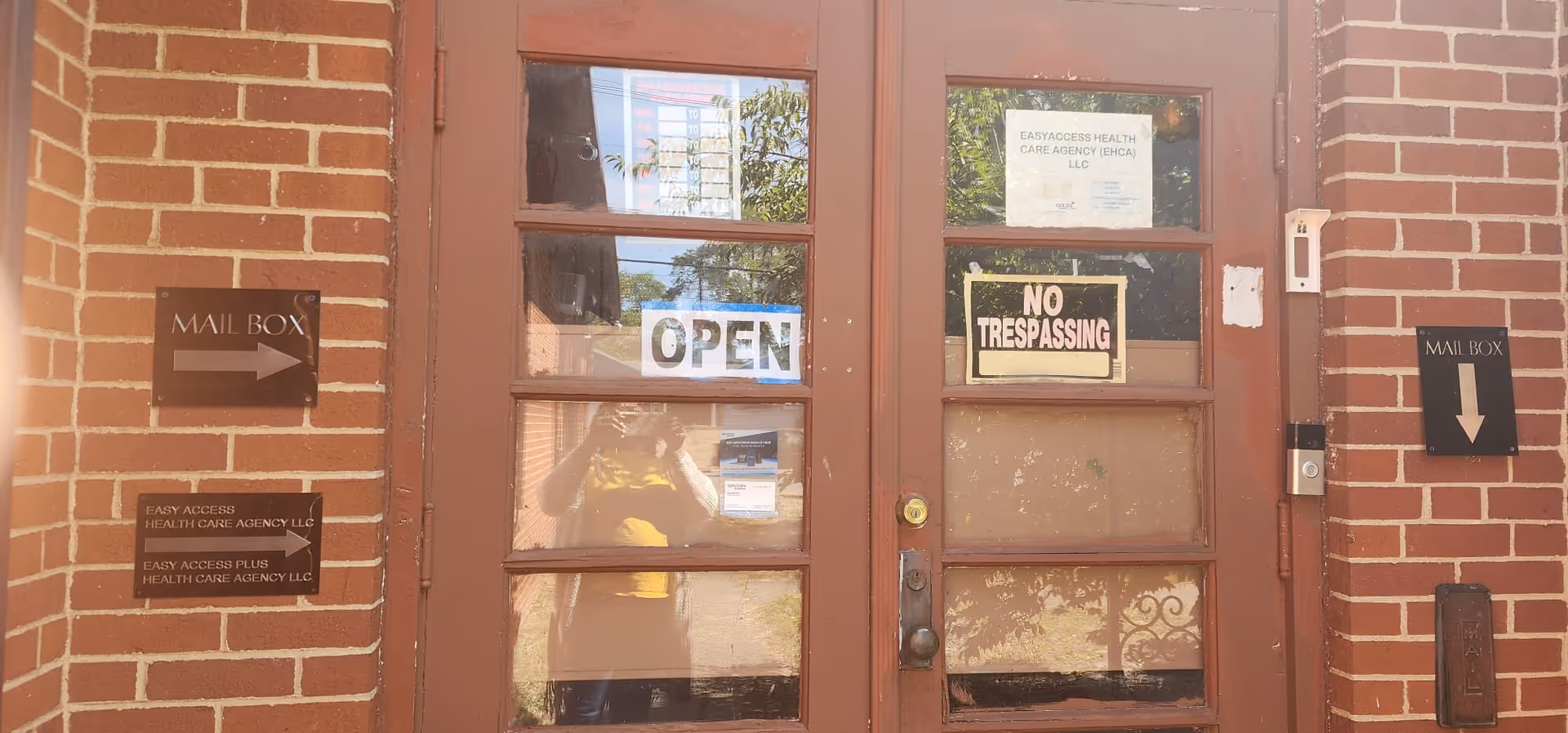 Brick entrance of Easyaccess Health Care Agency LLC with open sign and notices.