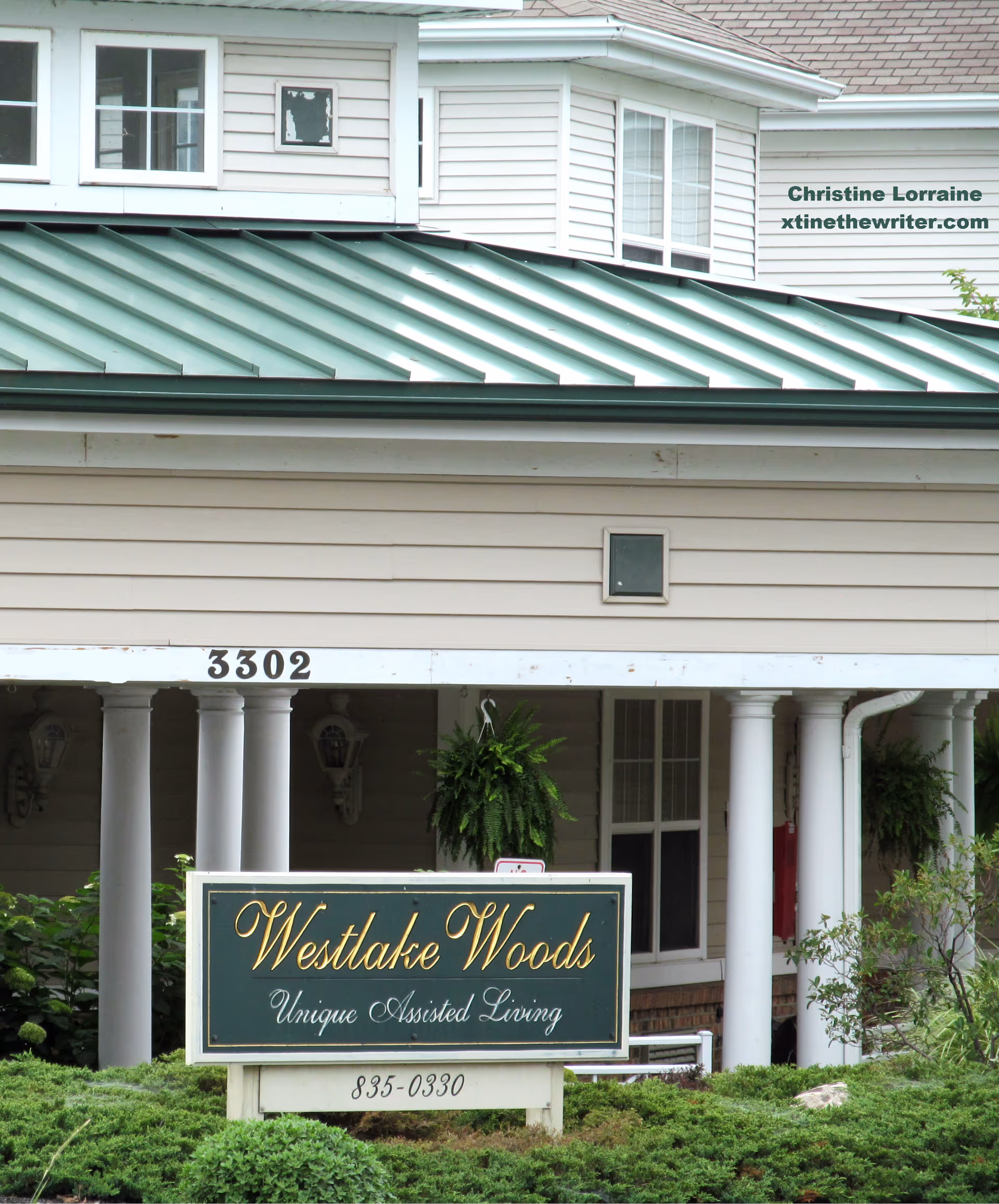 Front of Westlake Woods Assisted Living building with sign, columns, and greenery.