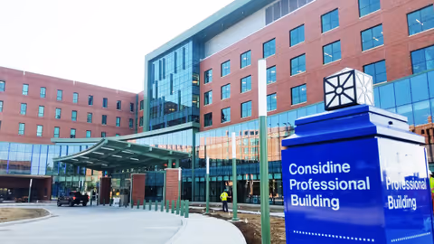 Exterior view of a brick medical building with a blue sign reading Considine Professional Building.