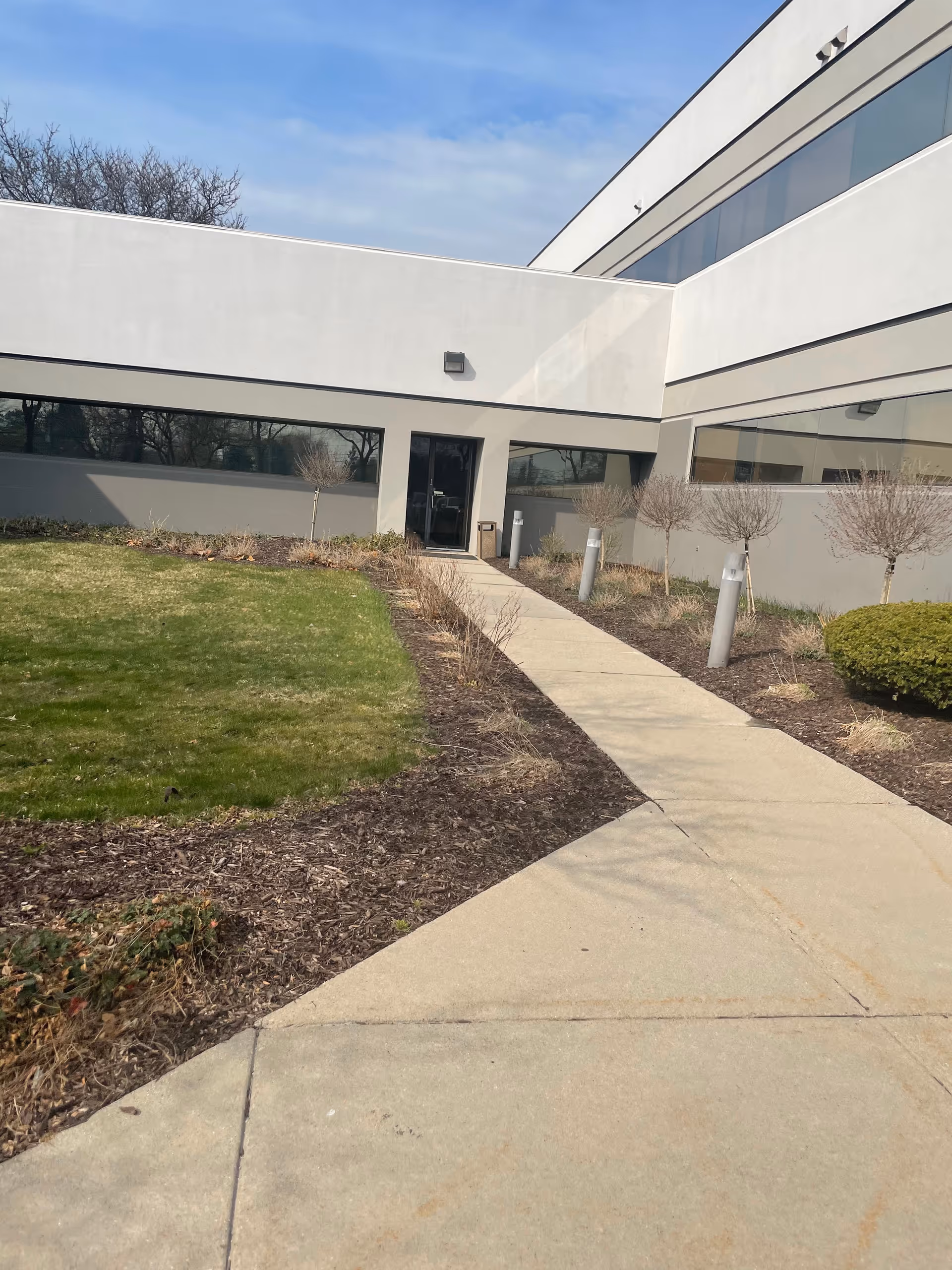 Exterior of VPS of MI PLLC building with walkway to the front entrance.