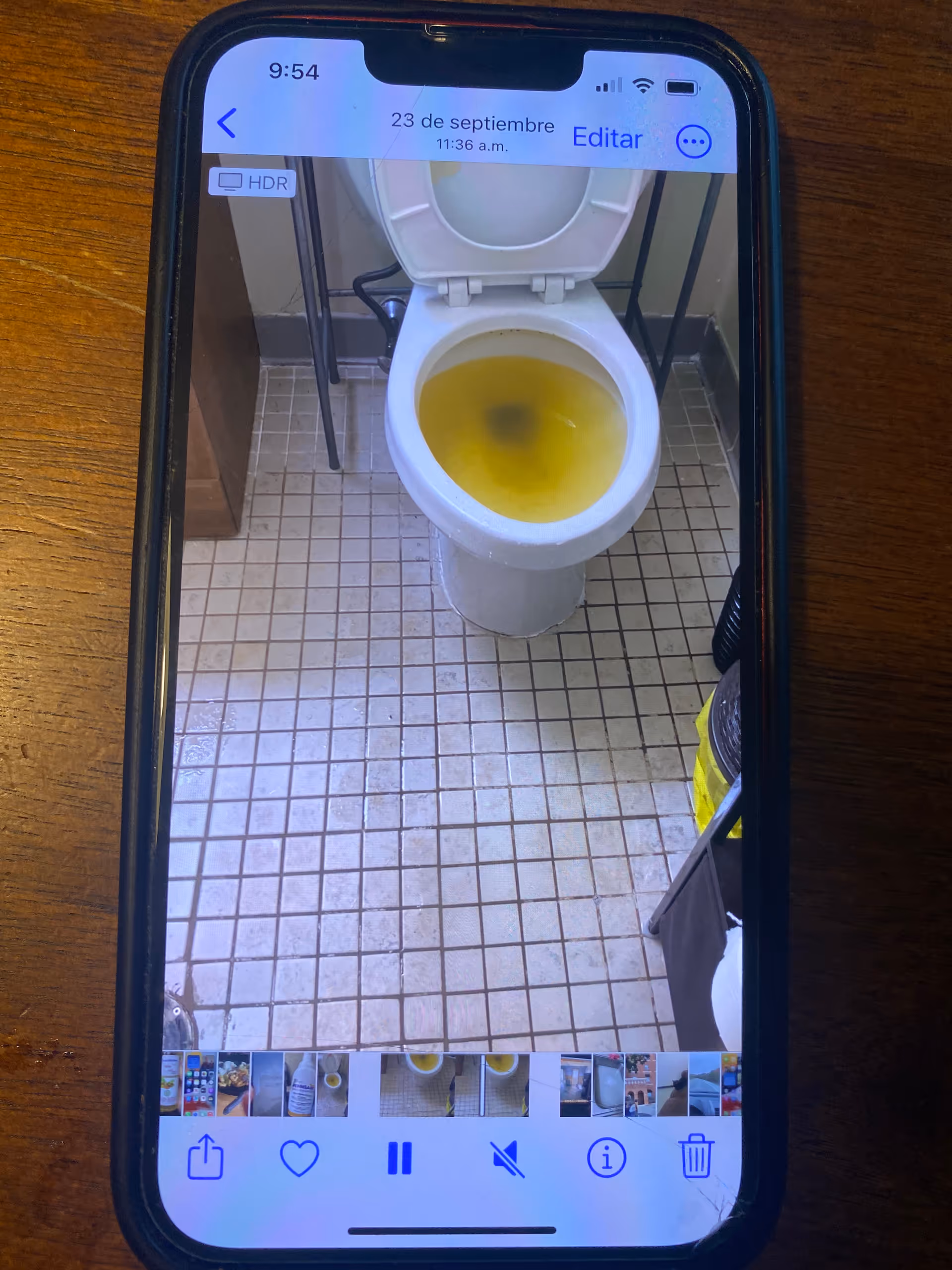 Toilet with yellow water in a tiled bathroom setting.