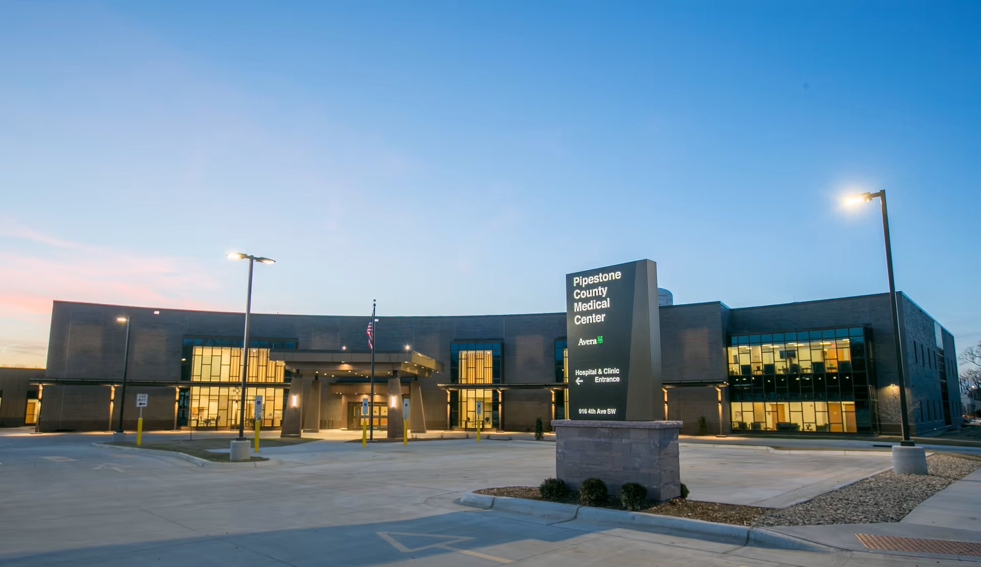 Exterior view of Pipestone County Medical Center & Family Clinic Avera at dusk.