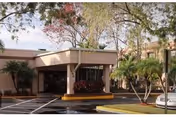 Exterior view of Tierra Pines Center entrance with covered drop-off and landscaping.