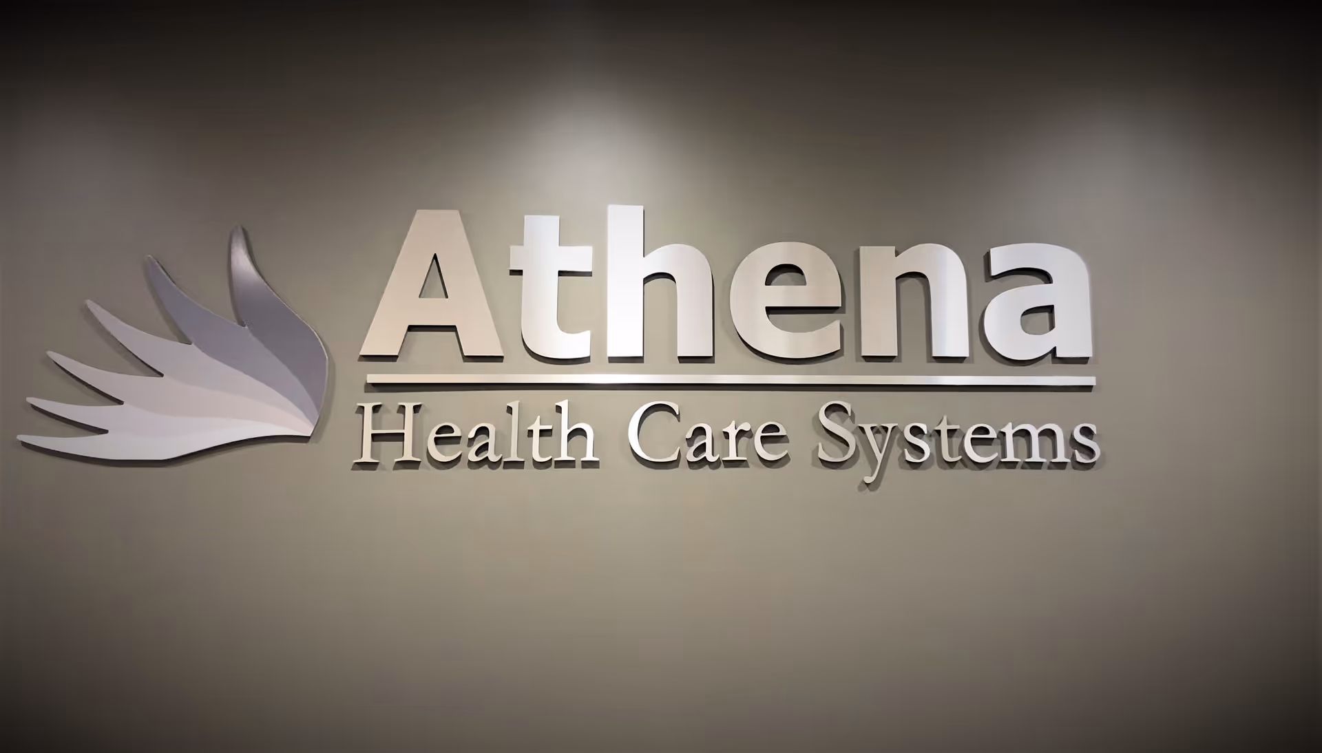 Interior wall featuring the Athena Health Care Systems logo sign.