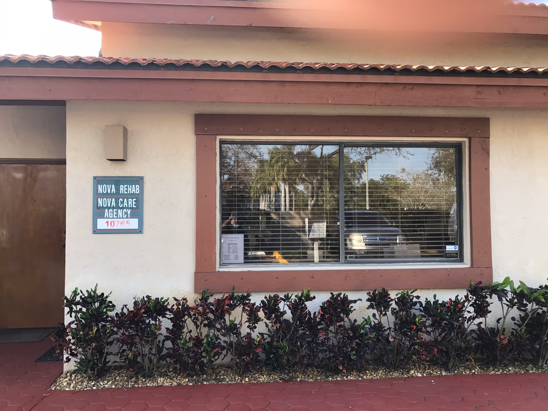 Exterior view of a facility with a sign for Nova Rehab and Nova Care Agency.