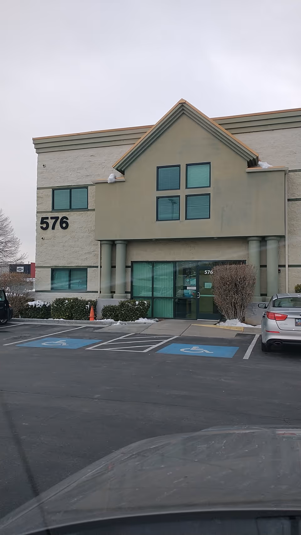 Exterior view of Rocky Mountain Care building entrance with handicap parking in front.