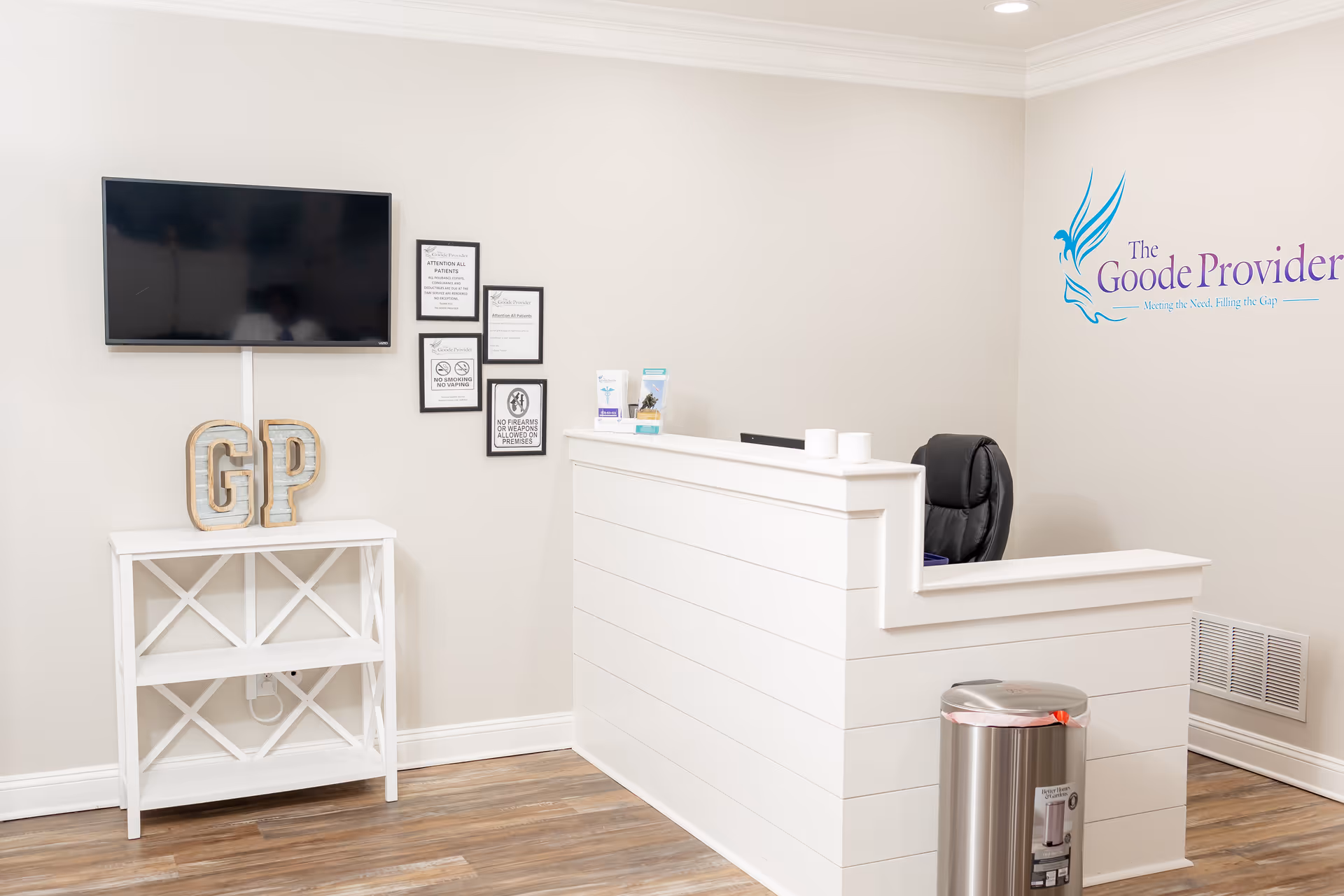 Reception desk in a modern senior living lobby with GP logo on wall.