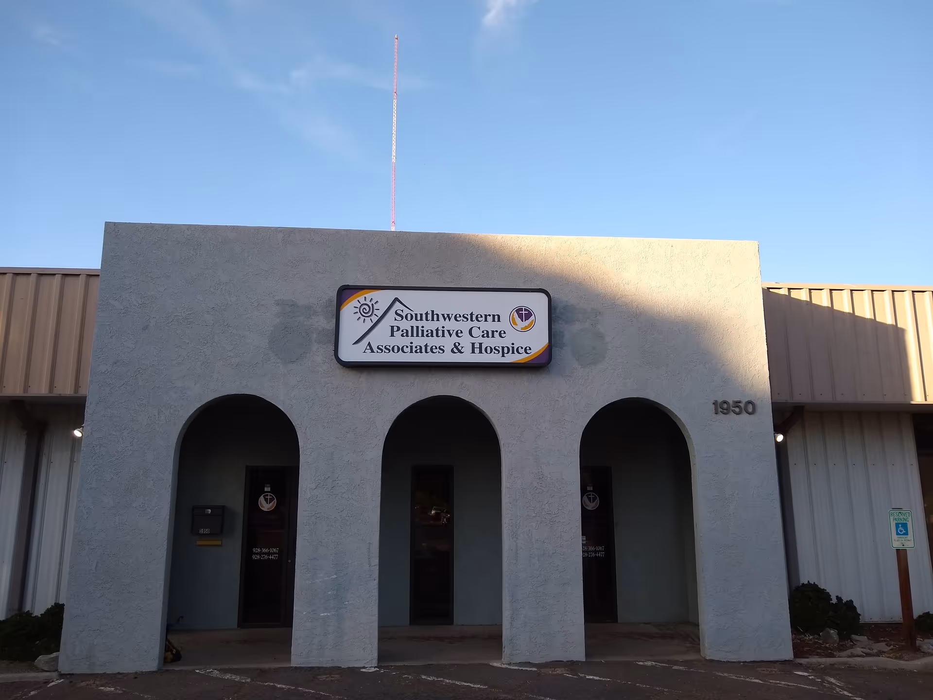 Exterior view of a building with three arches and a sign reading Southwestern Palliative Care