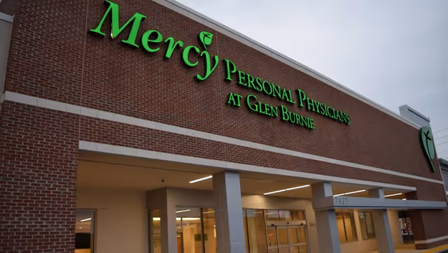 Brick storefront with green Mercy Personal Physicians signage and glass entrance doors.