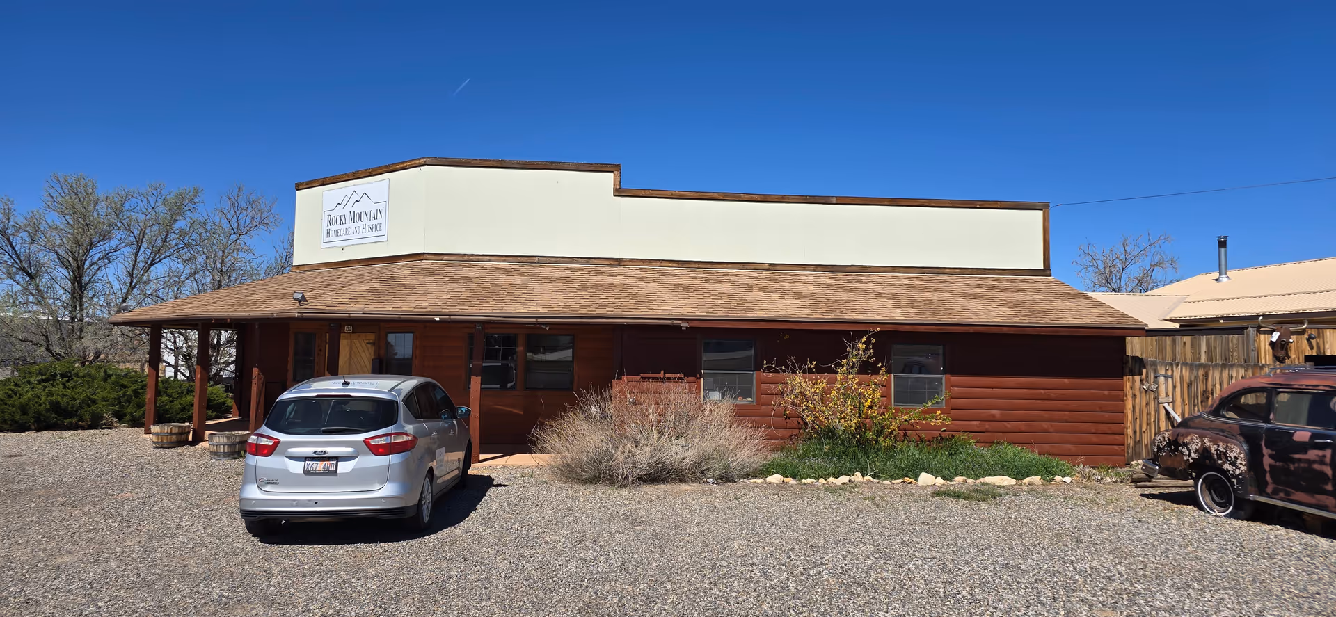Front view of Rocky Mountain Home Care & Hospice in Blanding, single-story building with gravel parking.