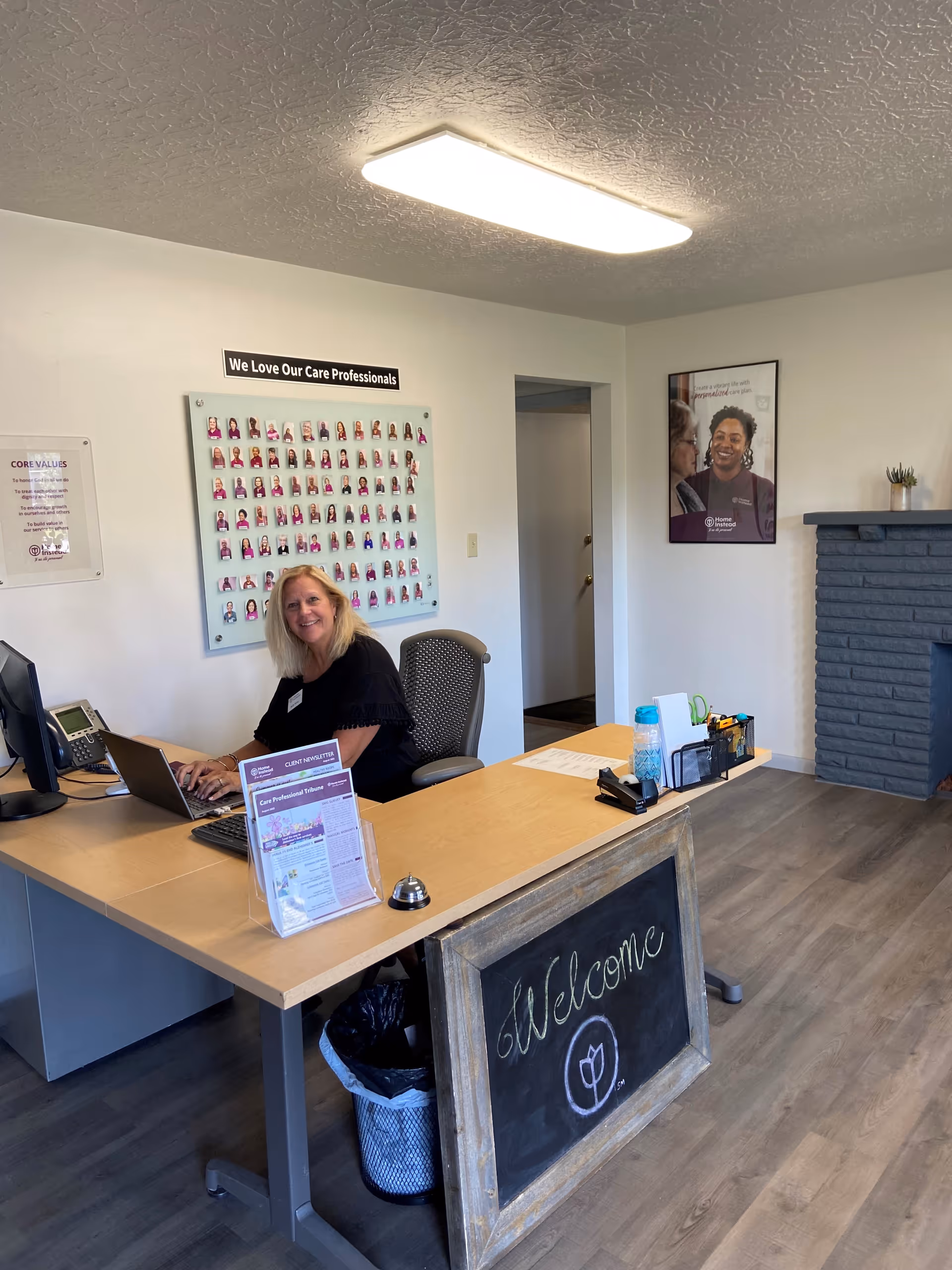 Reception desk with a smiling staff member in a senior care facility lobby