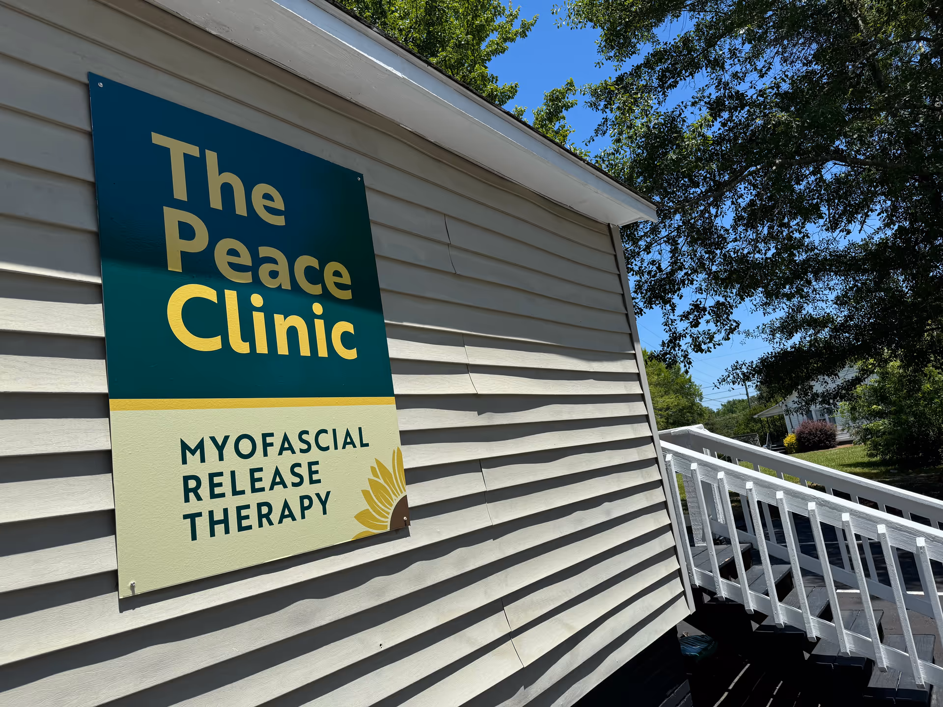 Exterior view of a building with a sign that reads The Peace Clinic, Myofascial Release Therapy.