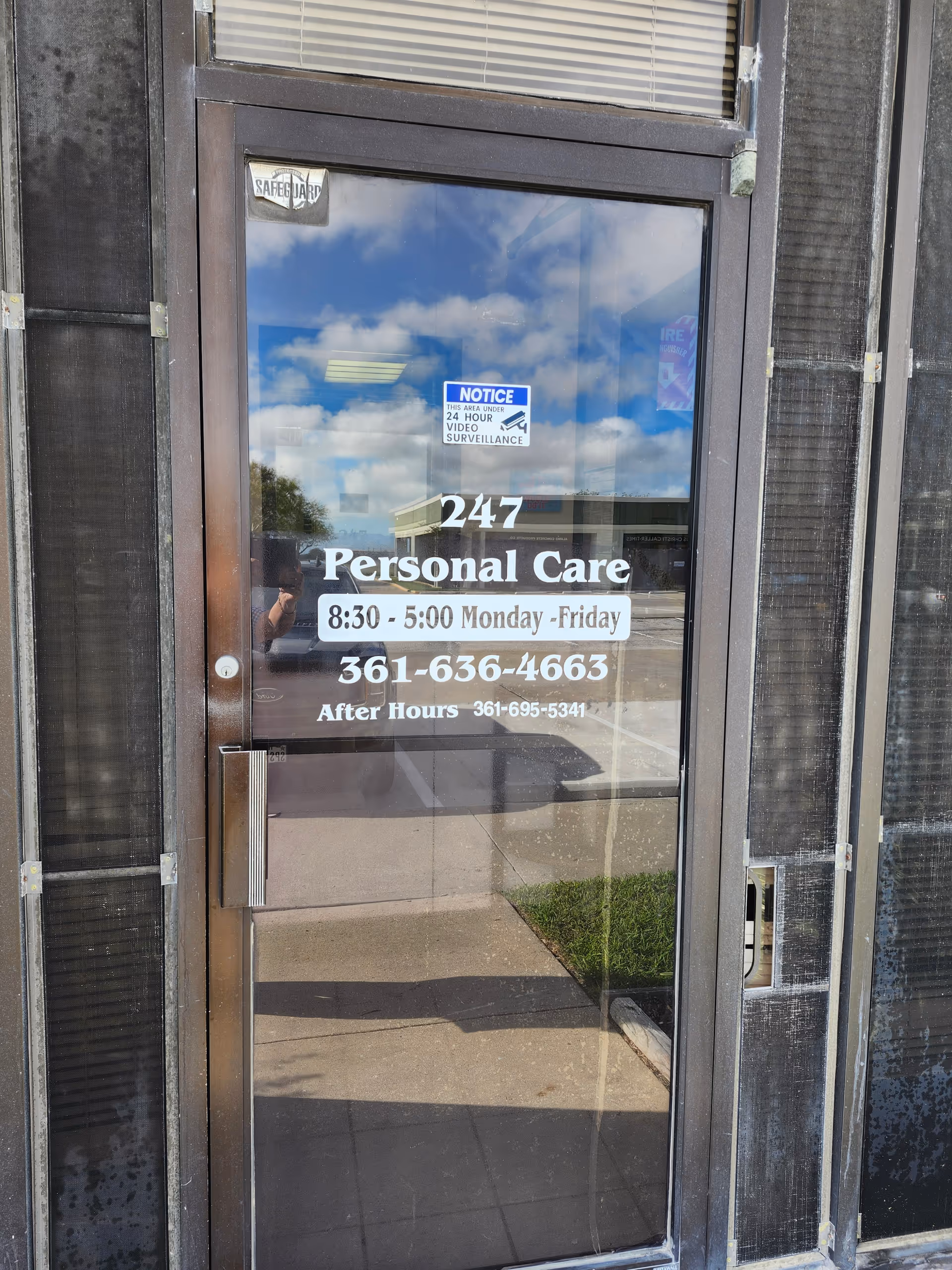 Glass entrance door showing 247 Personal Care signage and operating hours.