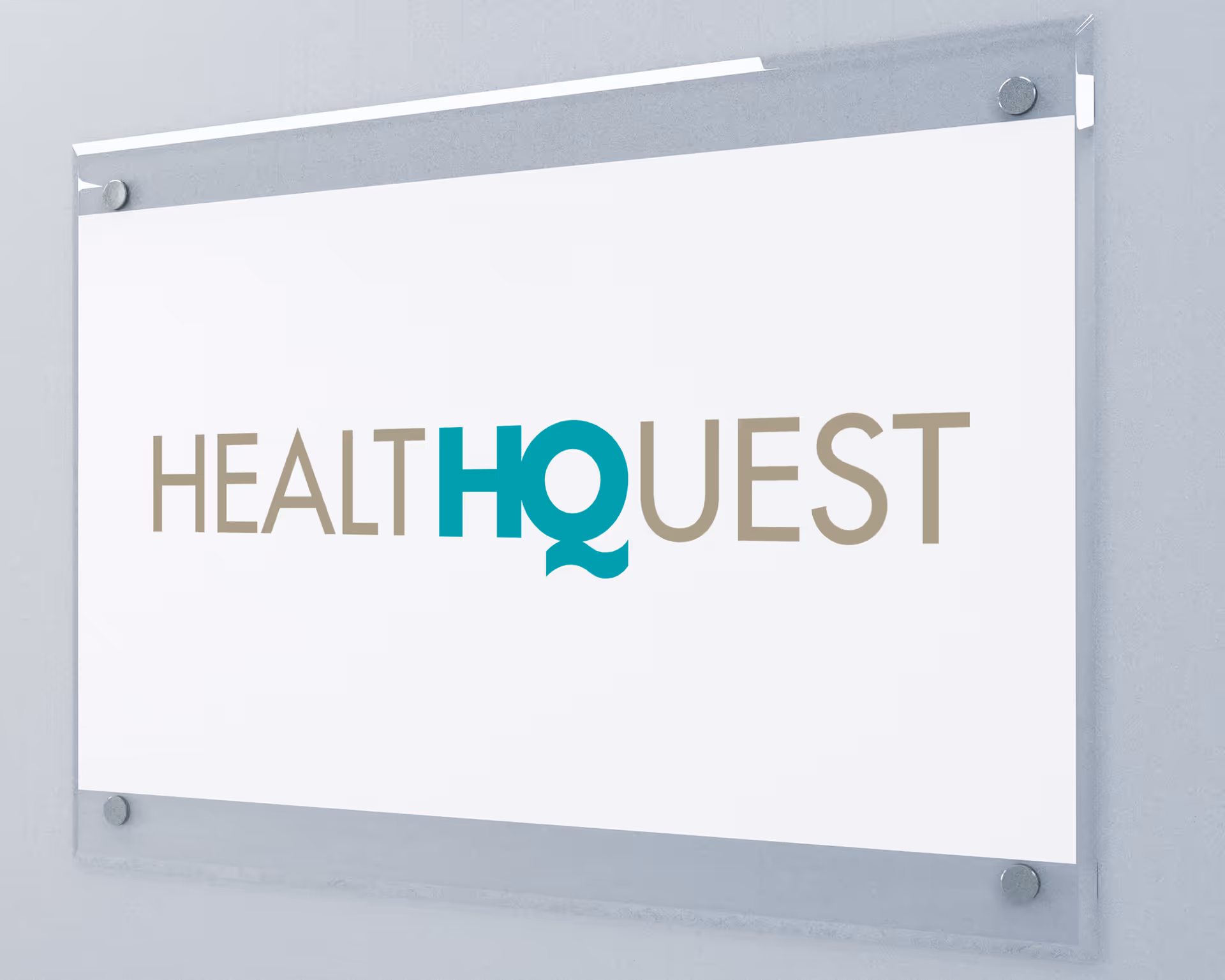 Interior wall sign displaying Health Quest branding with teal Q accent.