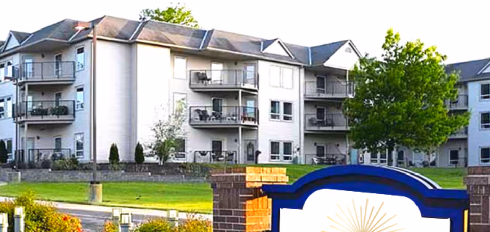 Exterior view of Celebration Villa of Hearthstone West with balconies and manicured lawn.