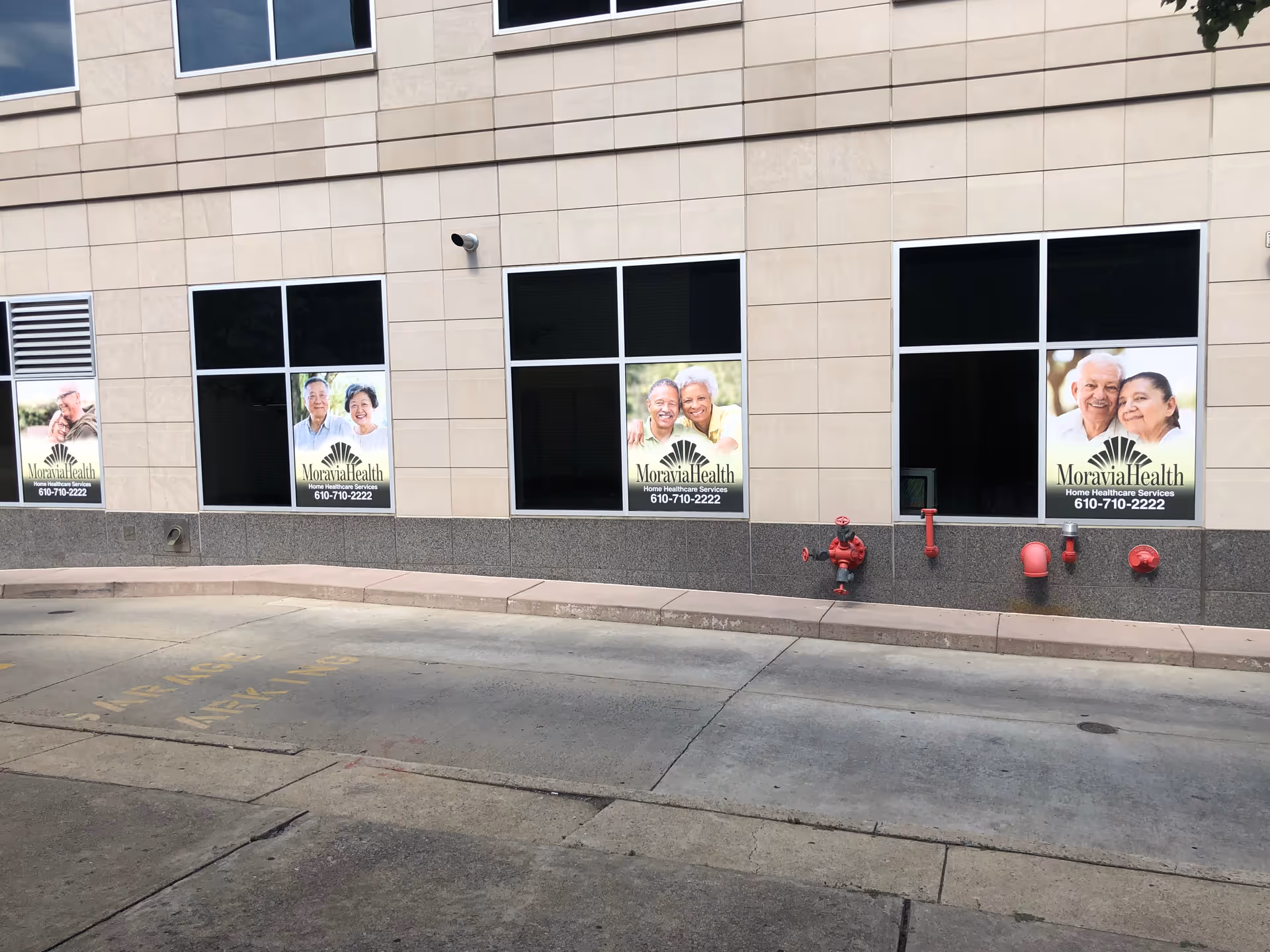 Exterior view of Moravia Health Allentown building with large windows and posters.