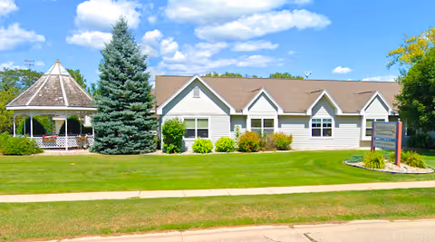 Front view of Shepherd Premier Senior Living, a single-story facility with gazebo and manicured lawn.