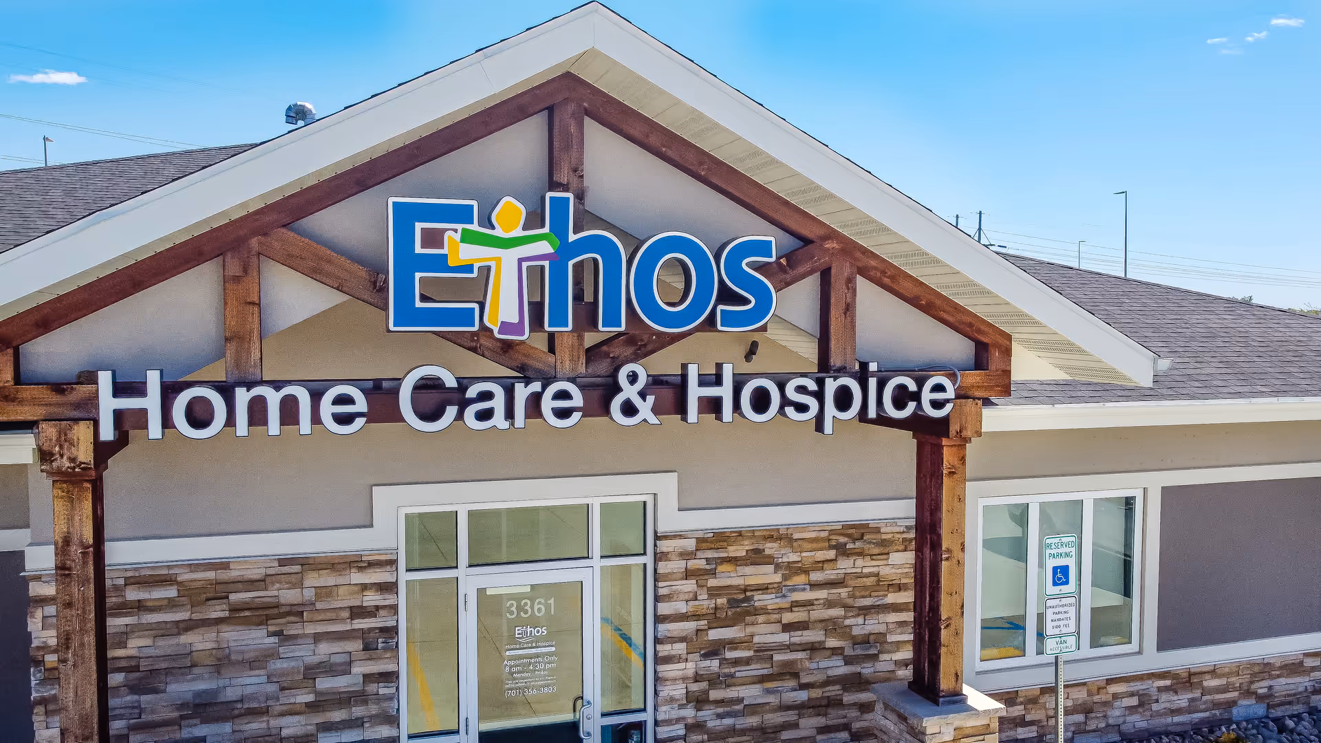 Front view of Ethos Home Care & Hospice building with sign and stone facade