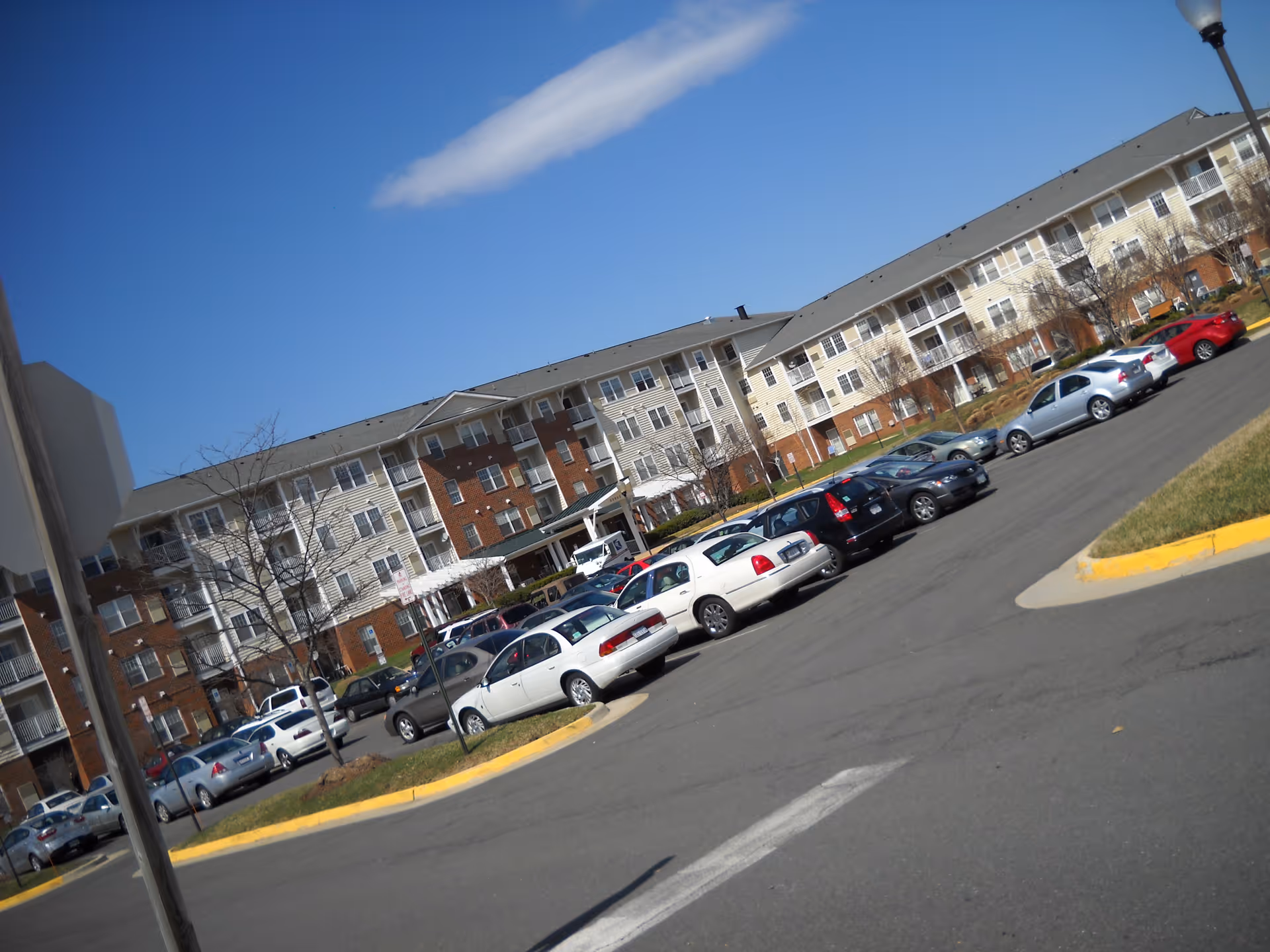 Exterior view of Wingler House senior living building with a parking lot and cars.