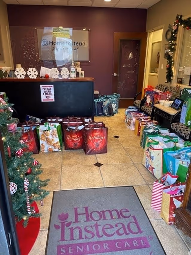 Reception area with gift bags and holiday decor at Home Instead Senior Care