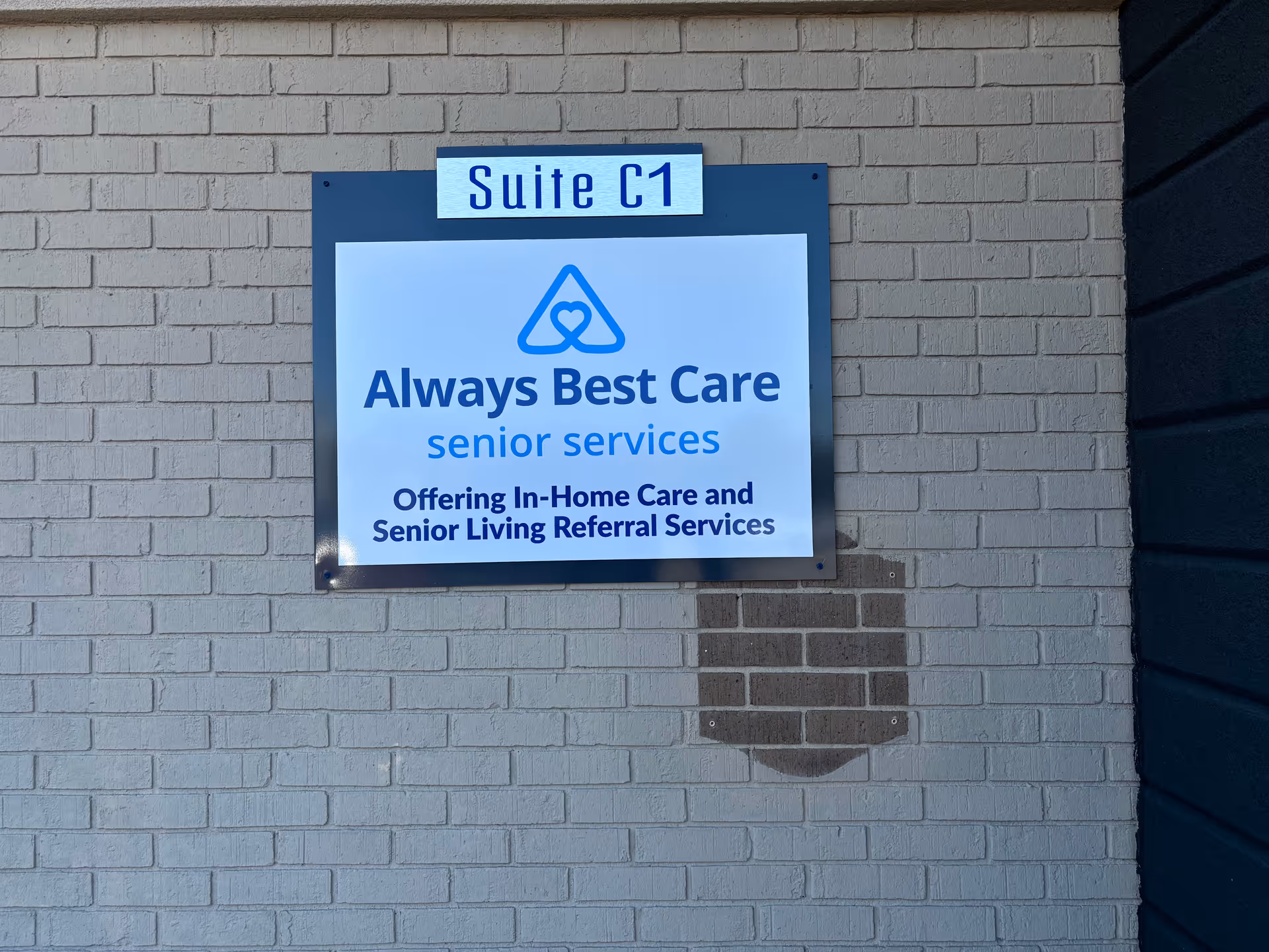 Exterior wall with a blue and white Always Best Care sign reading Suite C1