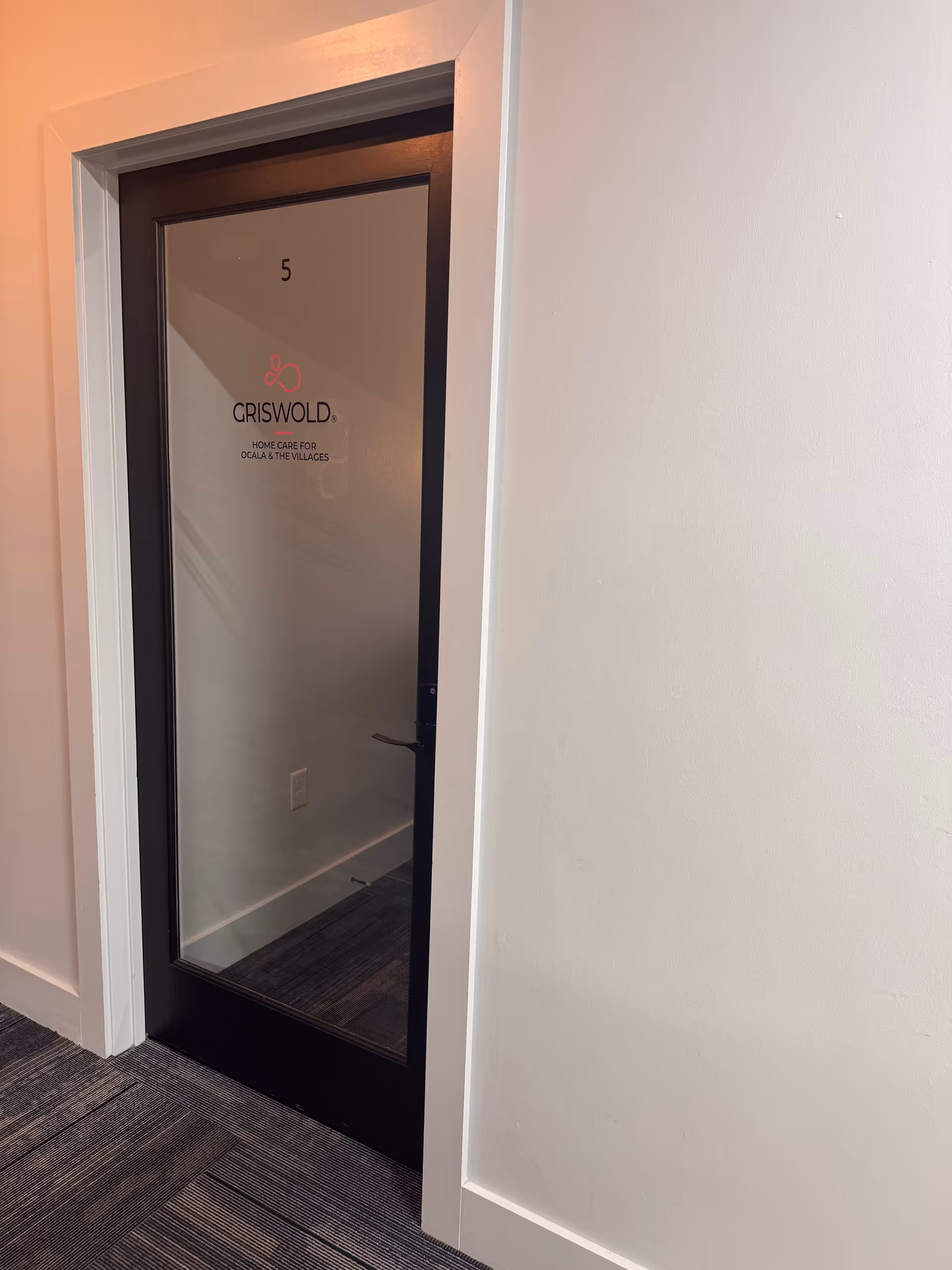Interior glass door marked 5 with Griswold branding in hallway.