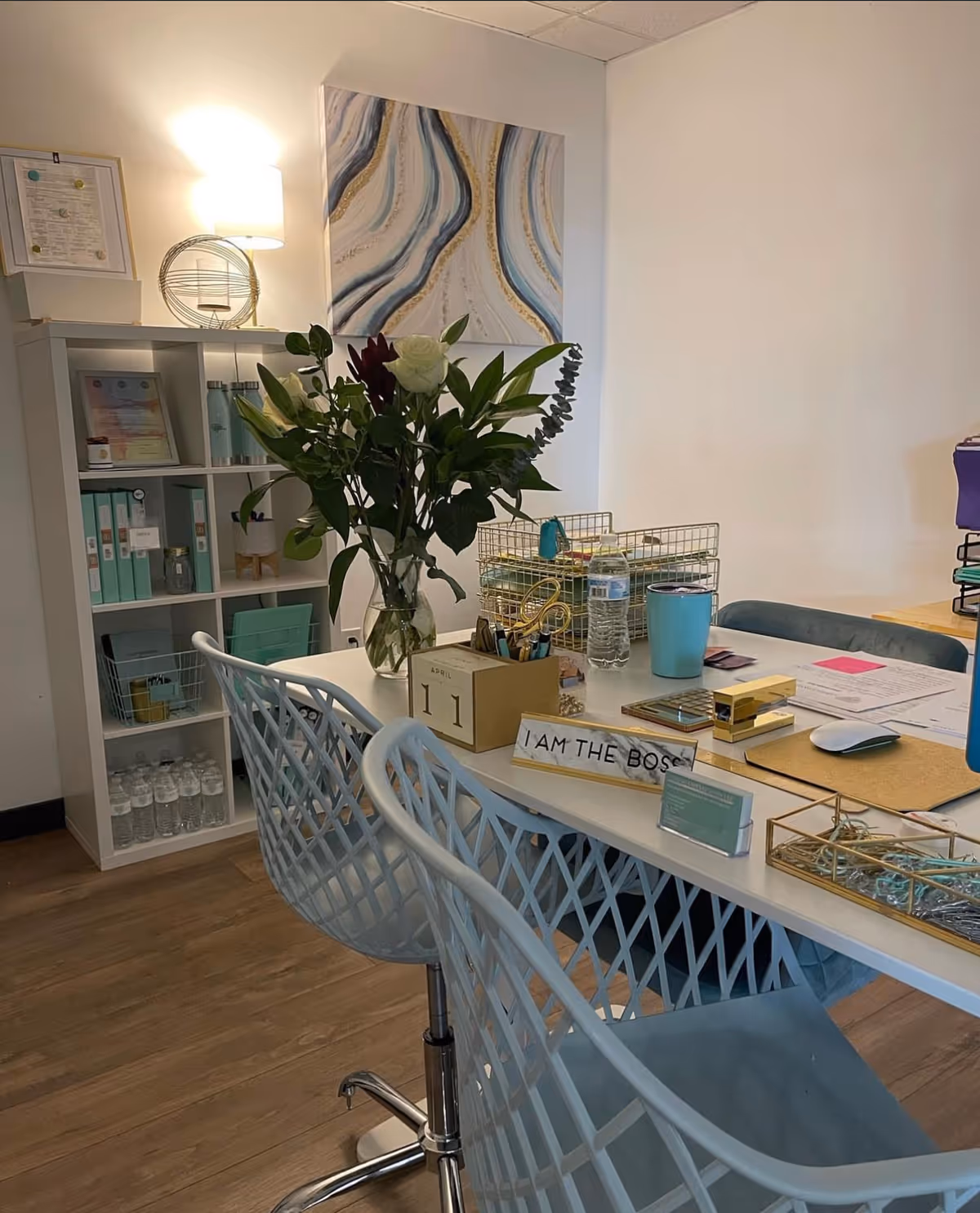 A tidy office desk with flowers and organizers inside a Caring Connectors facility.