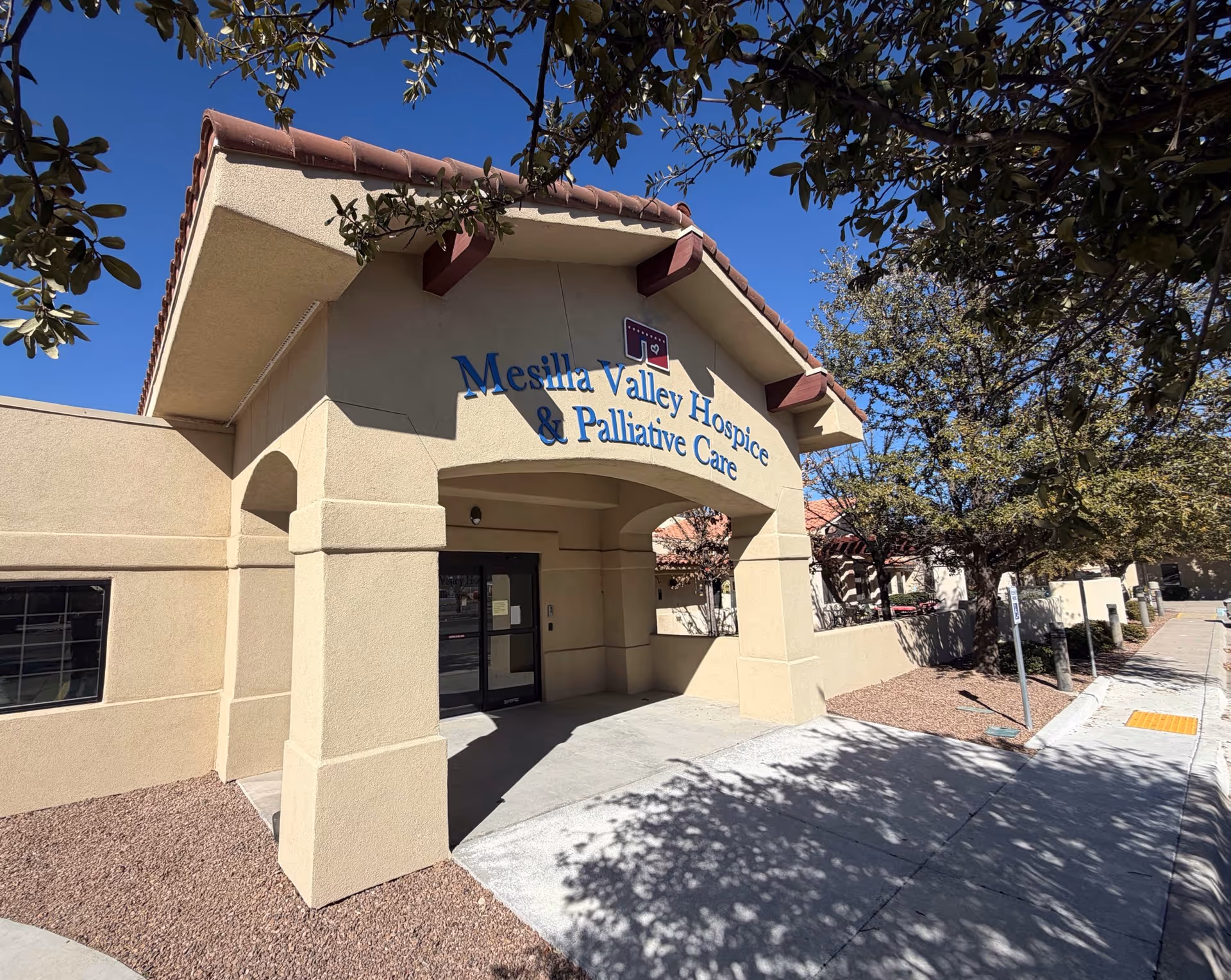 Exterior view of Mesilla Valley Hospice building entrance with blue signage.