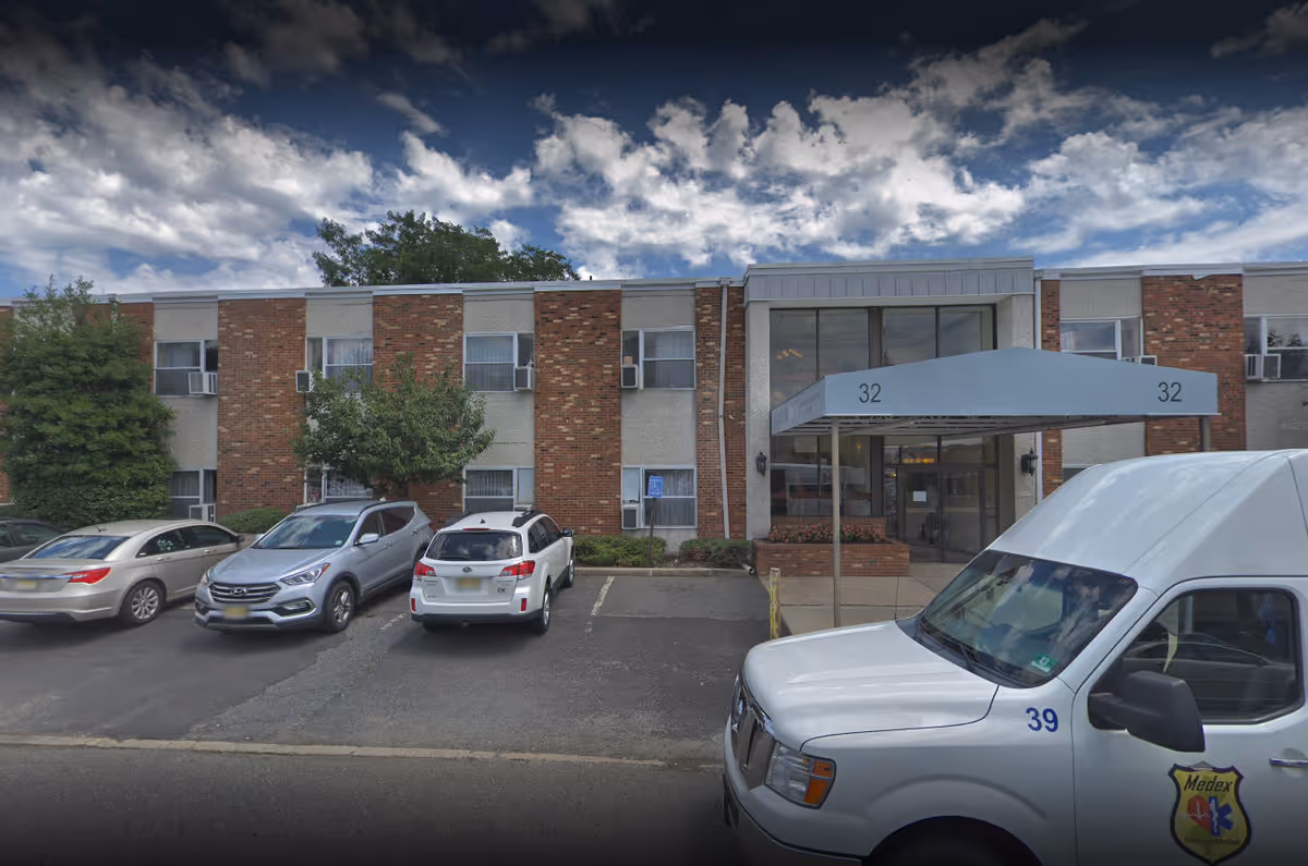 Exterior view of Laurel Bay Health & Rehabilitation Center entrance with parked cars.