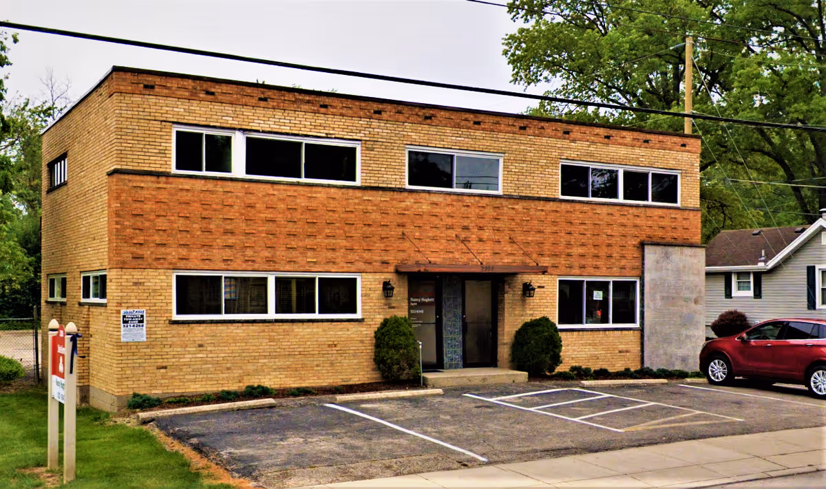 Two story brick building with a parking lot and entrance, labeled Hunter Home Care of Cincinnati.