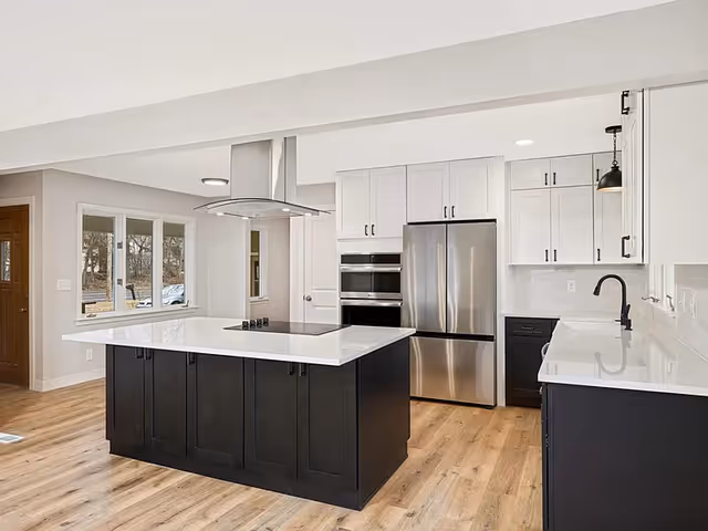 Modern kitchen in a senior living facility with a large island and stainless appliances.