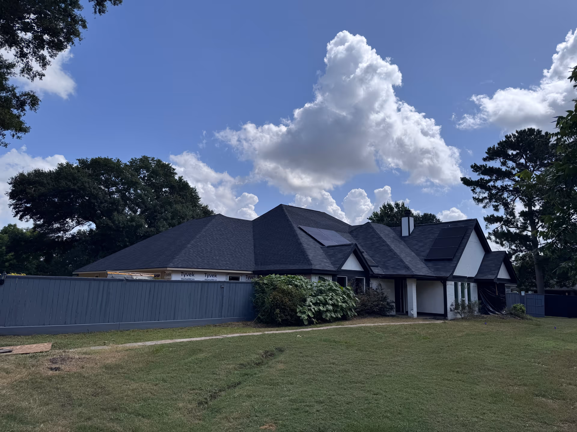 A single-story senior living facility with a dark roof and a grassy front yard.