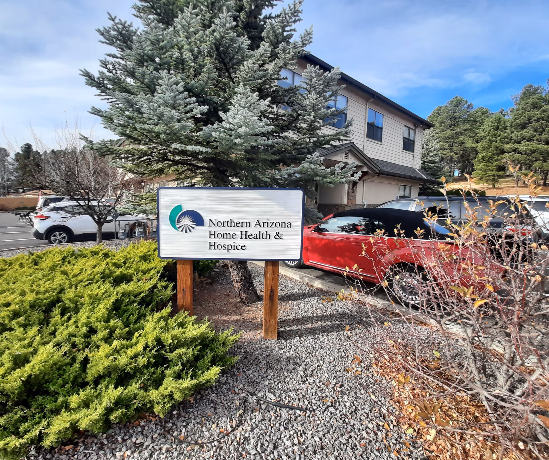 Exterior view of Northern Arizona Home Health & Hospice building with sign and vehicles.