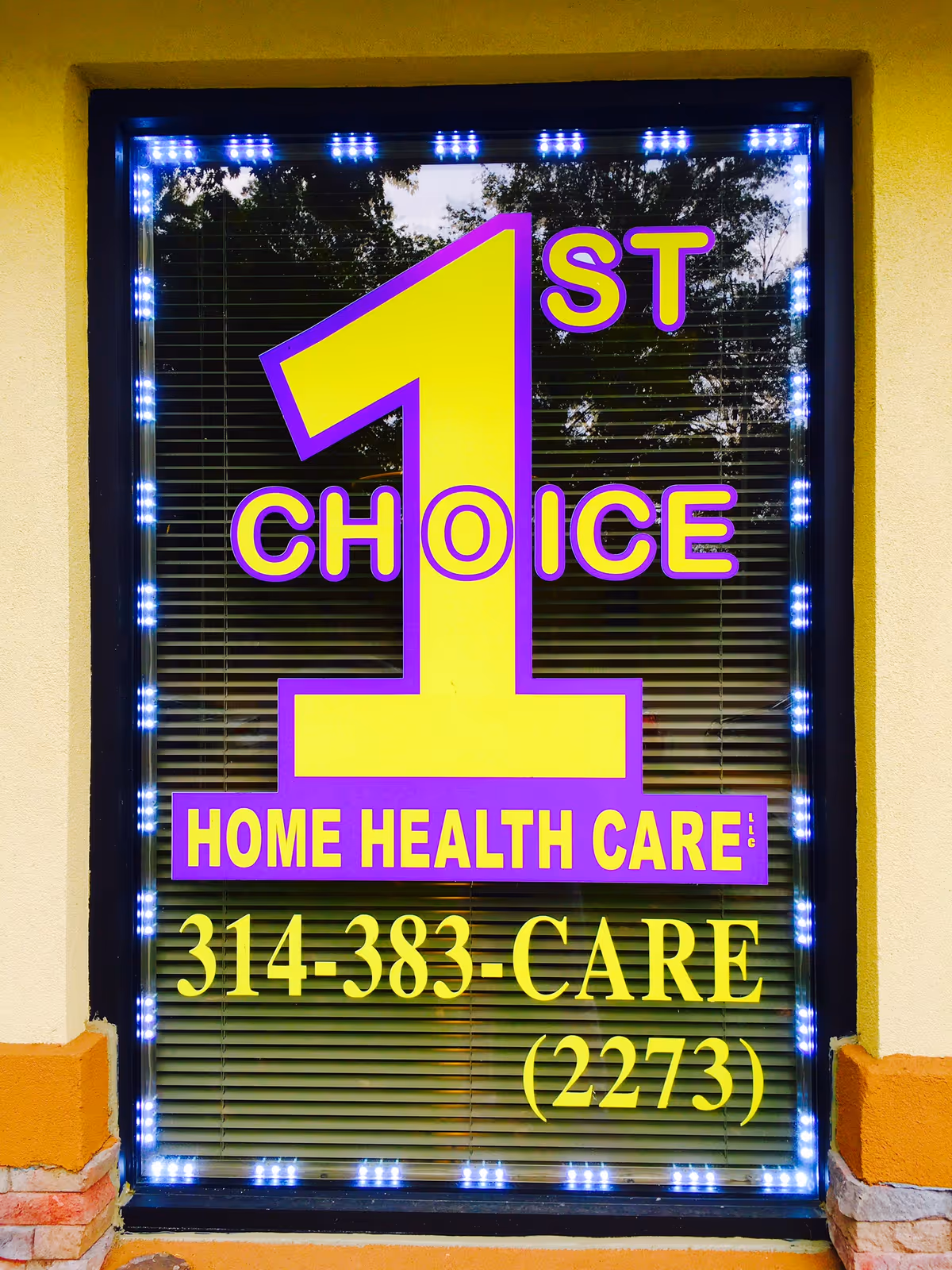 Storefront window sign for 1st Choice Home Health Care with bright yellow and purple lettering.
