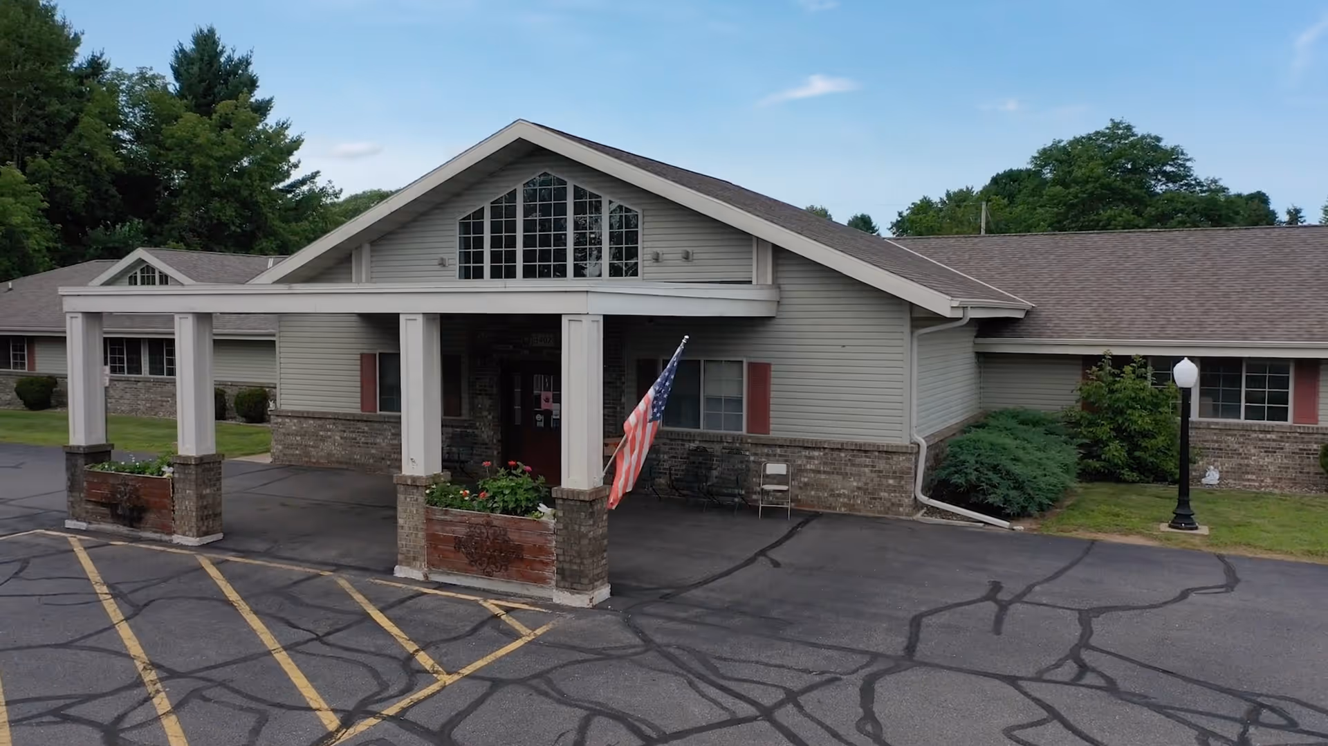 Mountain Terrace Senior Living exterior with covered entrance, American flag, and surrounding parking.