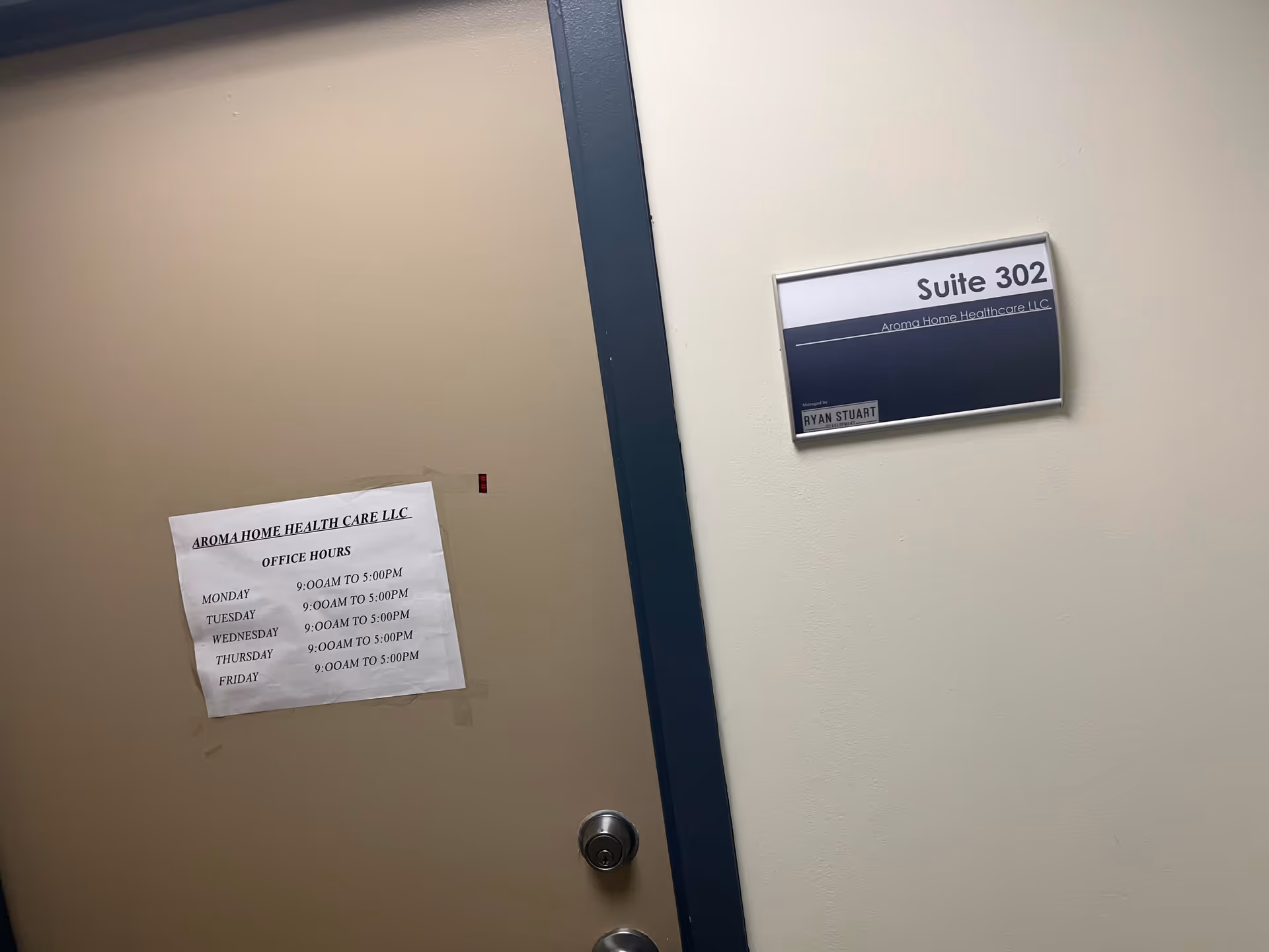Interior hallway with a door and Suite 302 sign for Aroma Home Healthcare LLC.