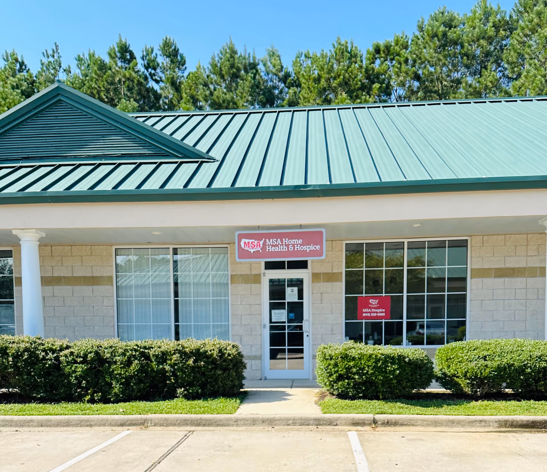 Front view of beige medical facility with green roof and MSA Home Health & Hospice sign.