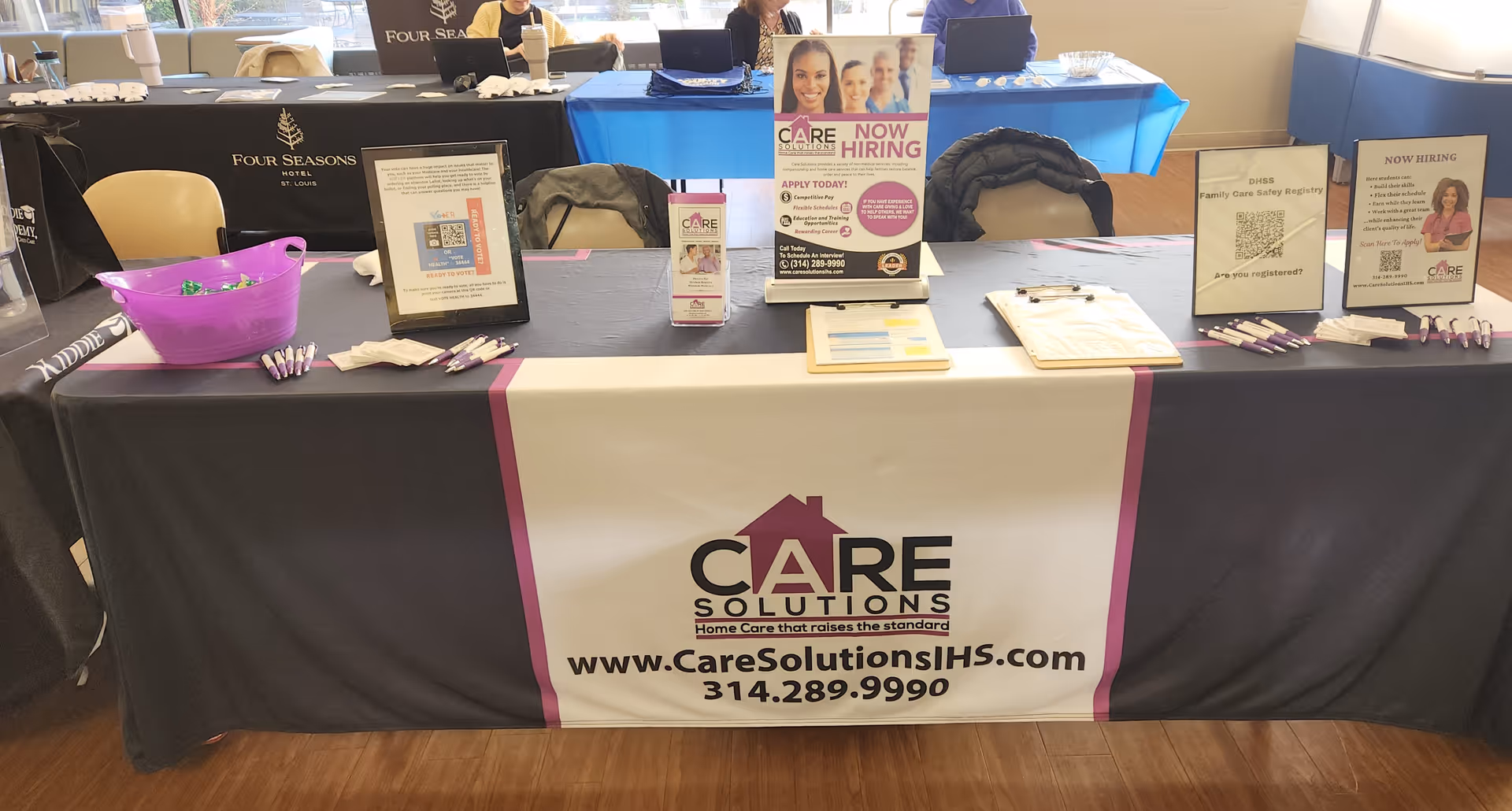 Promotional table at an indoor event for Care Solutions In-Home Services LLC.