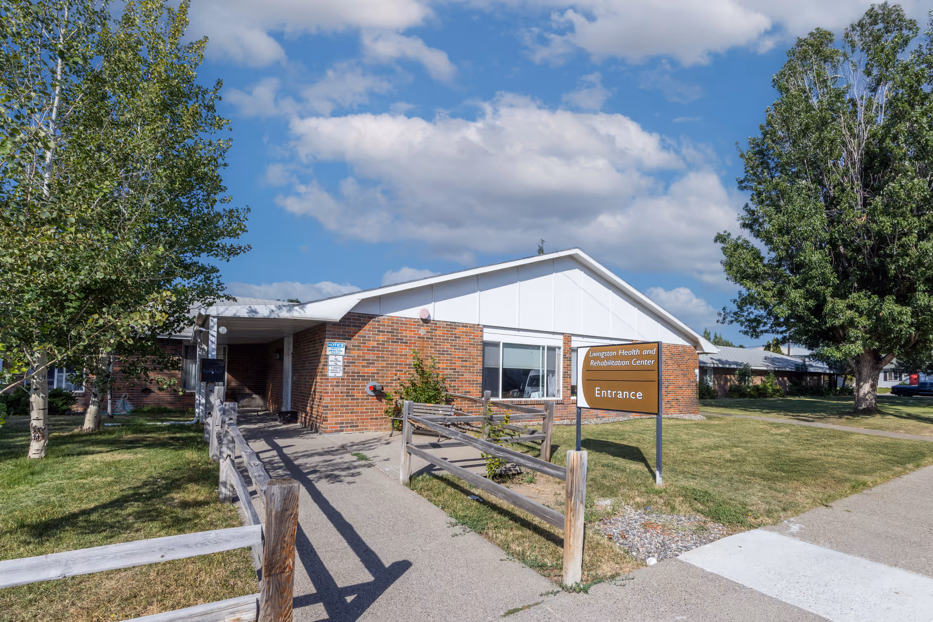 Exterior view of Livingston Health & Rehabilitation Center entrance with brick facade.