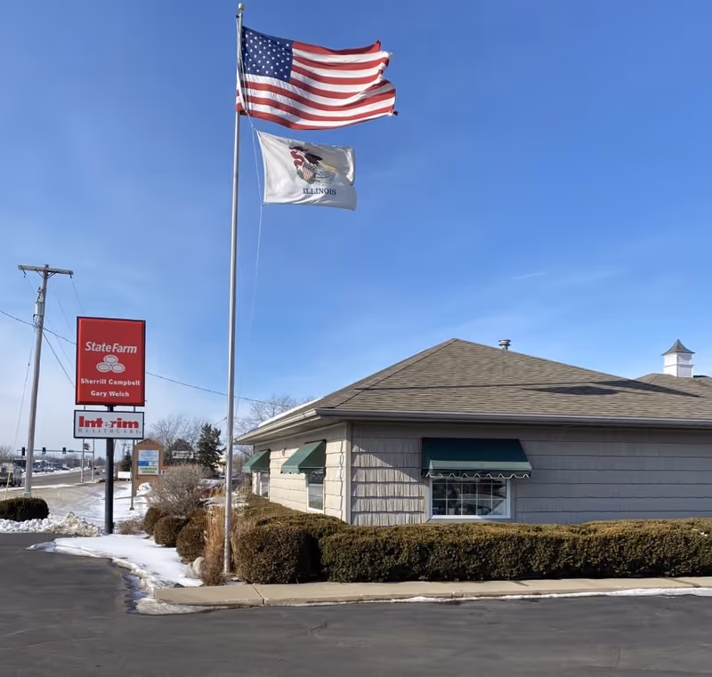 Exterior view of Interim HealthCare building with flags and signage.
