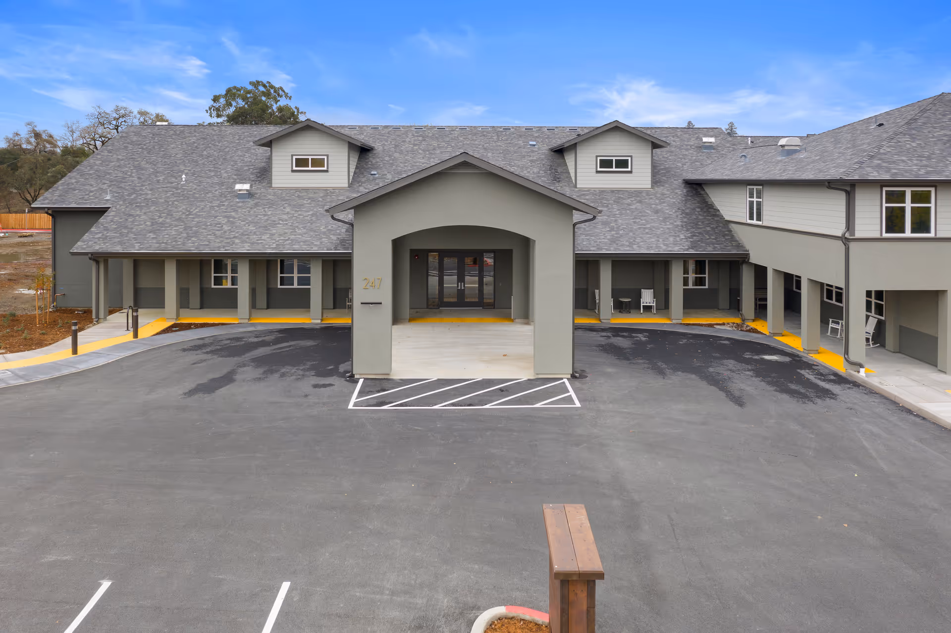 Front view of Vine Ridge Senior Living with covered entrance and surrounding parking.