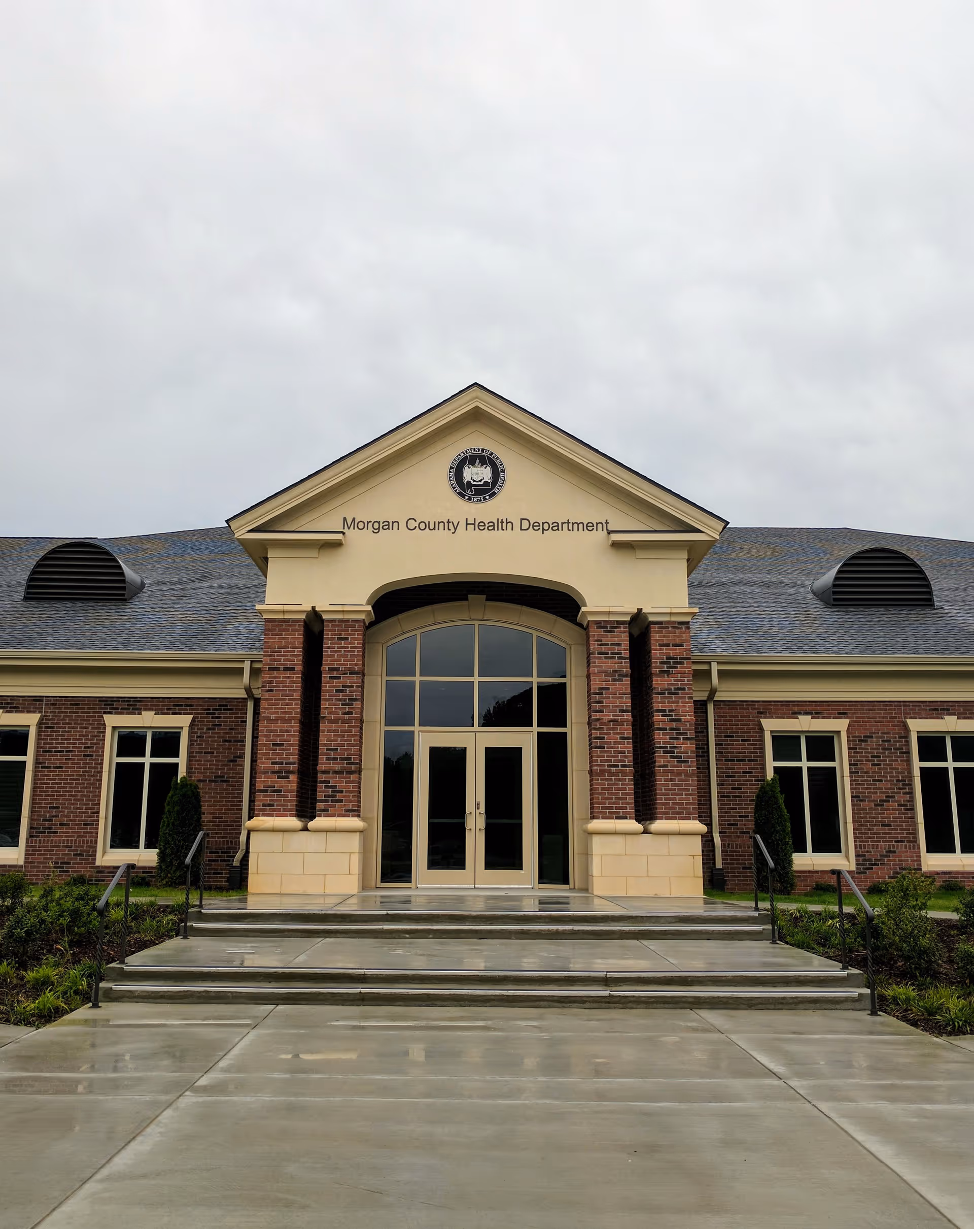 Front view of a brick Morgan County Health Department building with glass entrance doors