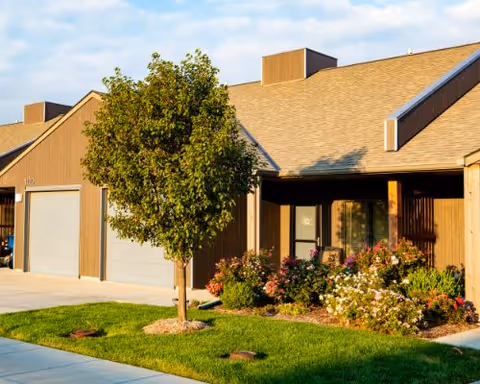 Exterior view of Dove Estates Senior Living Community building with manicured lawn.