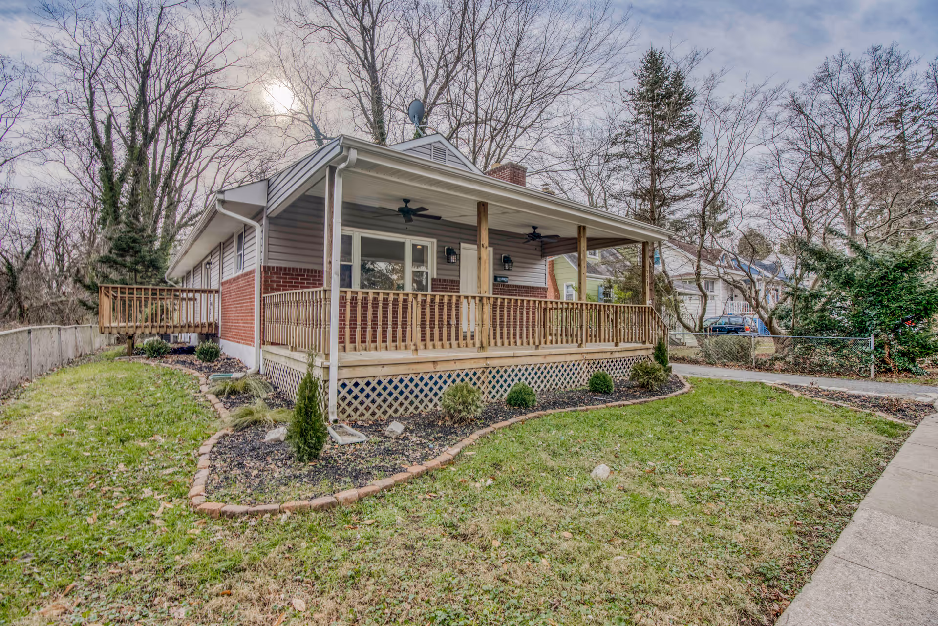 Single-story brick senior living home with a covered front porch and landscaped yard.
