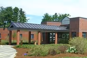 Exterior view of Desert Inn Residential Care: brick building, entrance, and surrounding landscaping.