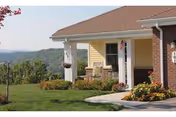 Front view of Serra Mesa Guests Home entrance with porch, lawn, and flowers.