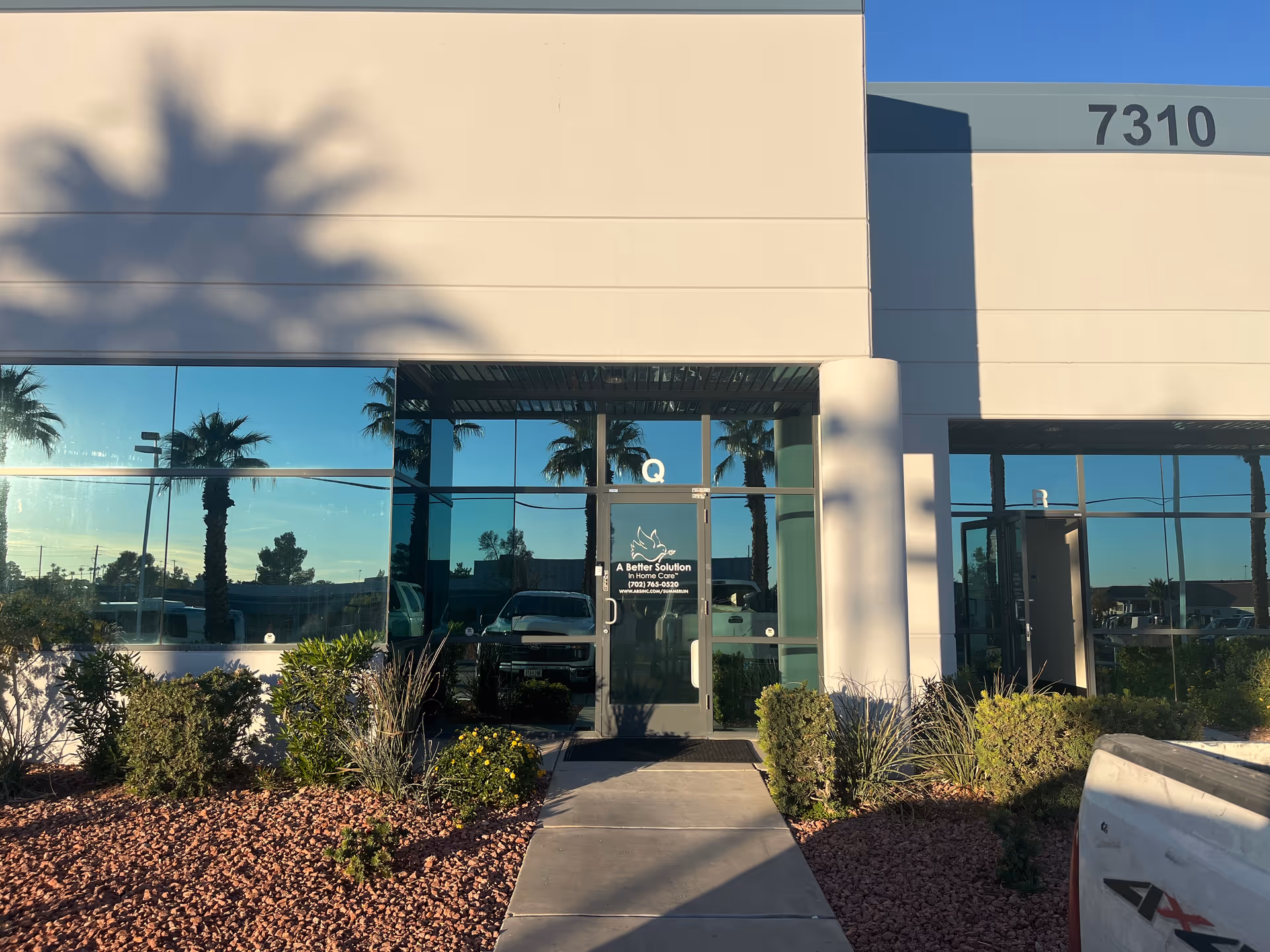 Front entrance of A Better Solution in Home Care Summerlin, with glass doors and desert landscaping.